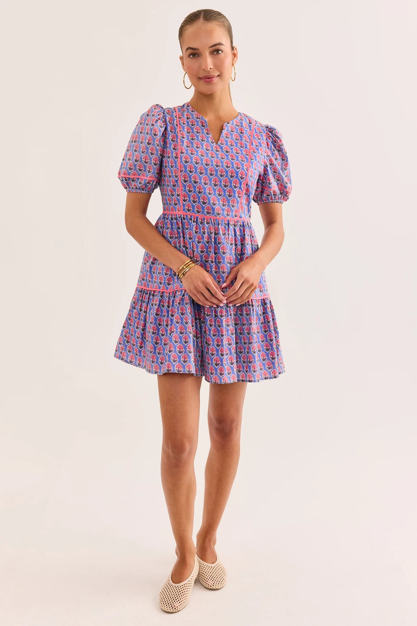 Woman wearing a patterned dress on a plain background lifestyle