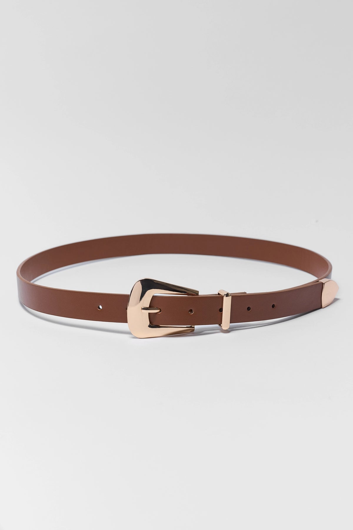 A brown leather belt with a rose gold buckle, displayed in a clean studio setting against a light gray background.