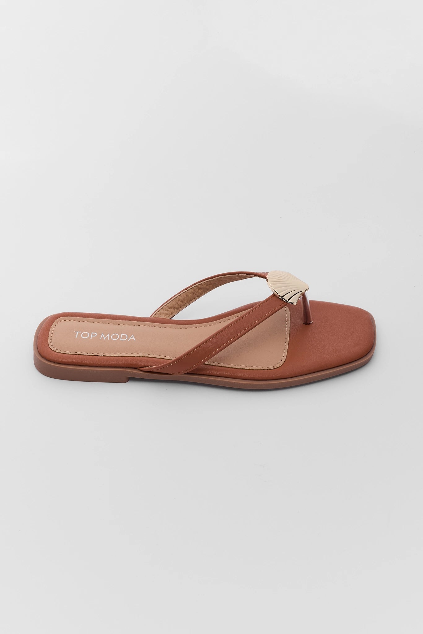 one Brown sandal with a thin strap on a light gray background