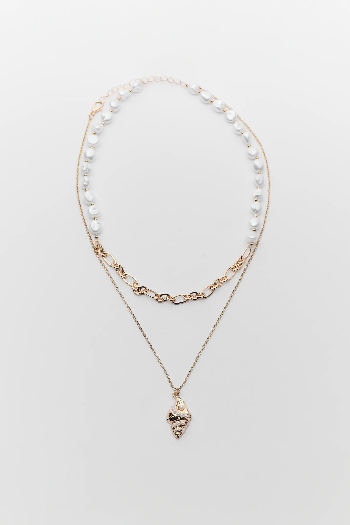 Two layered necklaces on a light gray background