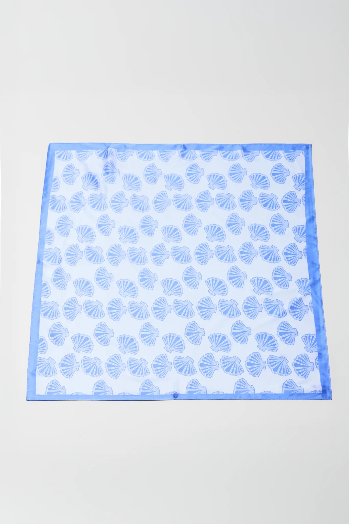 Blue patterned square on a light gray background