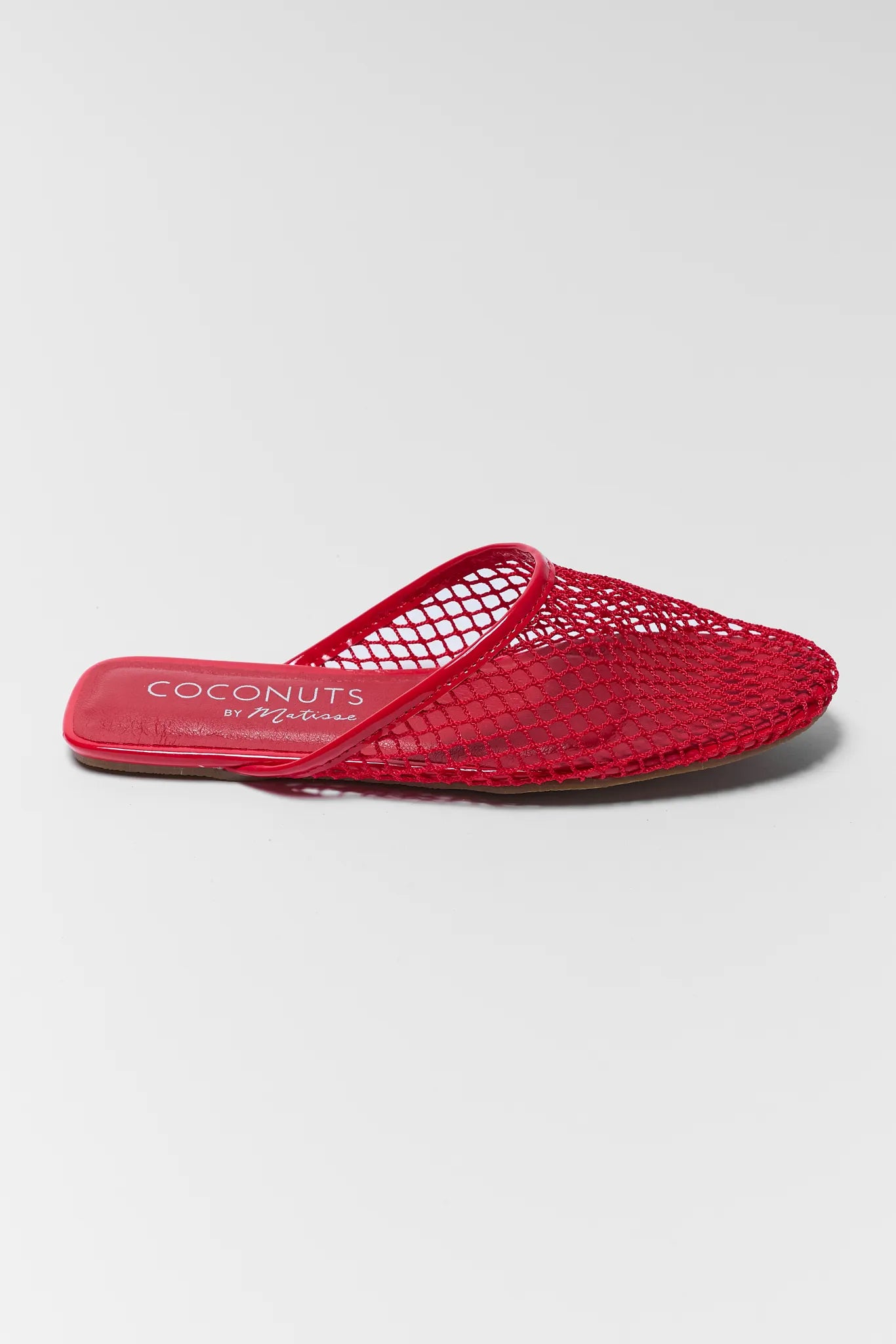 Red mesh sandal with 'Coconuts' branding on a white background