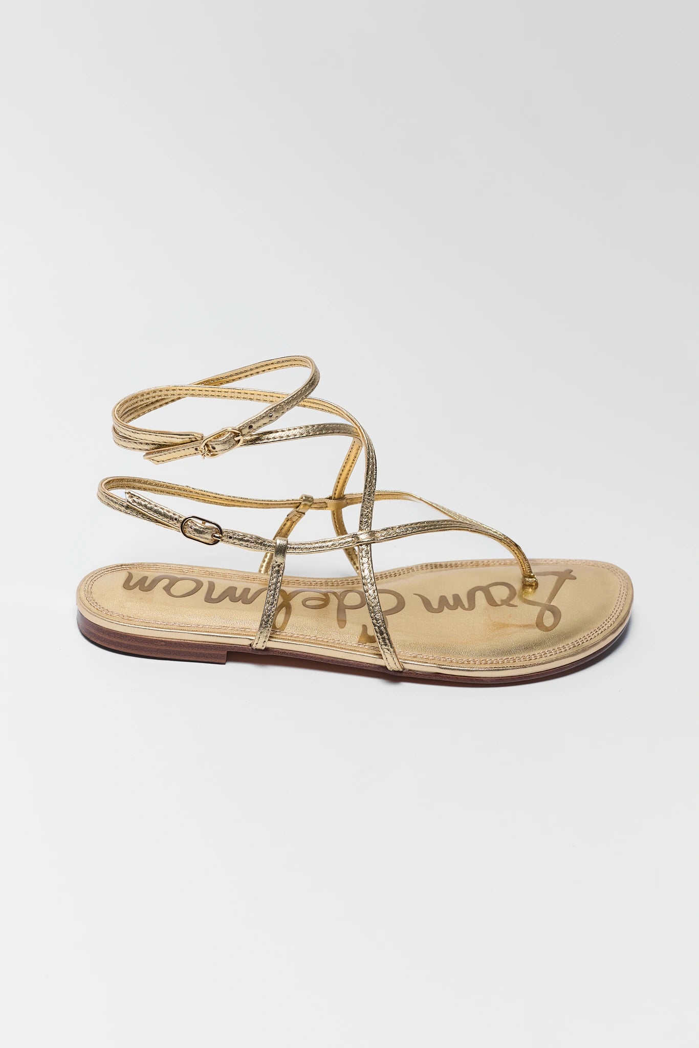 Gold sandal with 'Sam Edelman' branding on a white background one
