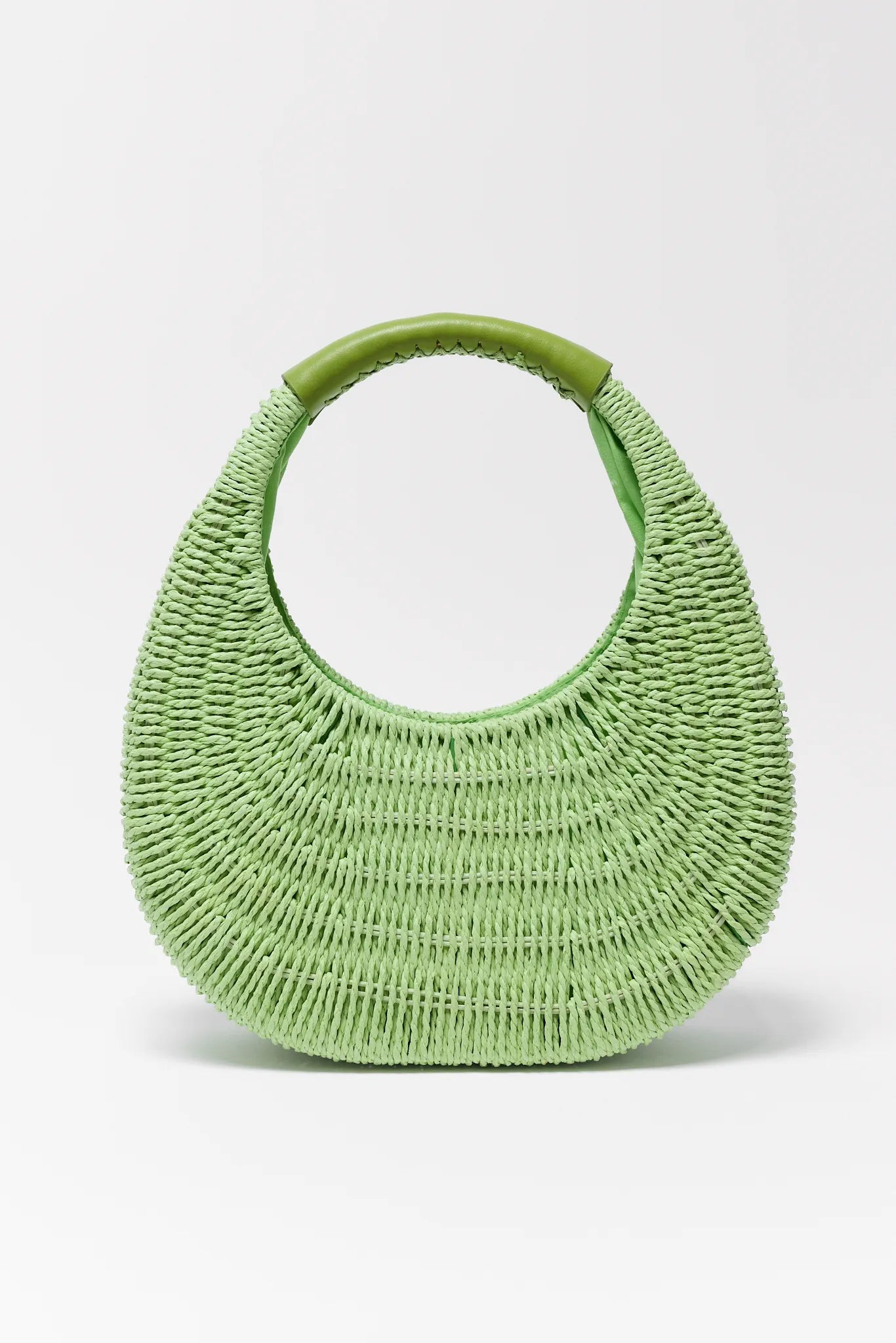 Green woven handbag on a light gray background