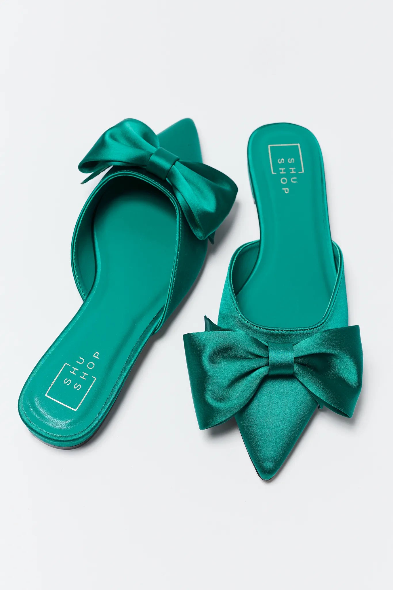 Teal Dottie Pointed Toe Bow Flats on a light gray background