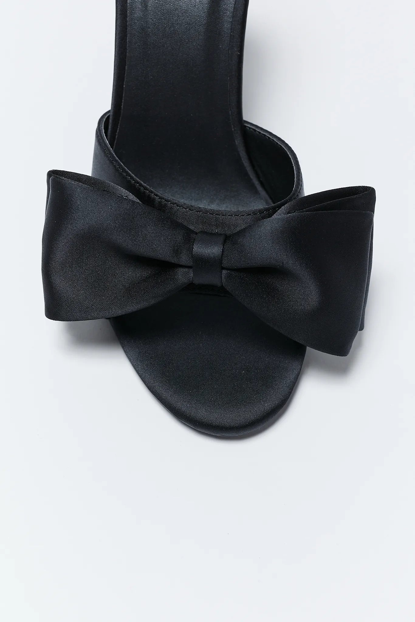 Elena Black Bow Heels with bow details on a light gray background