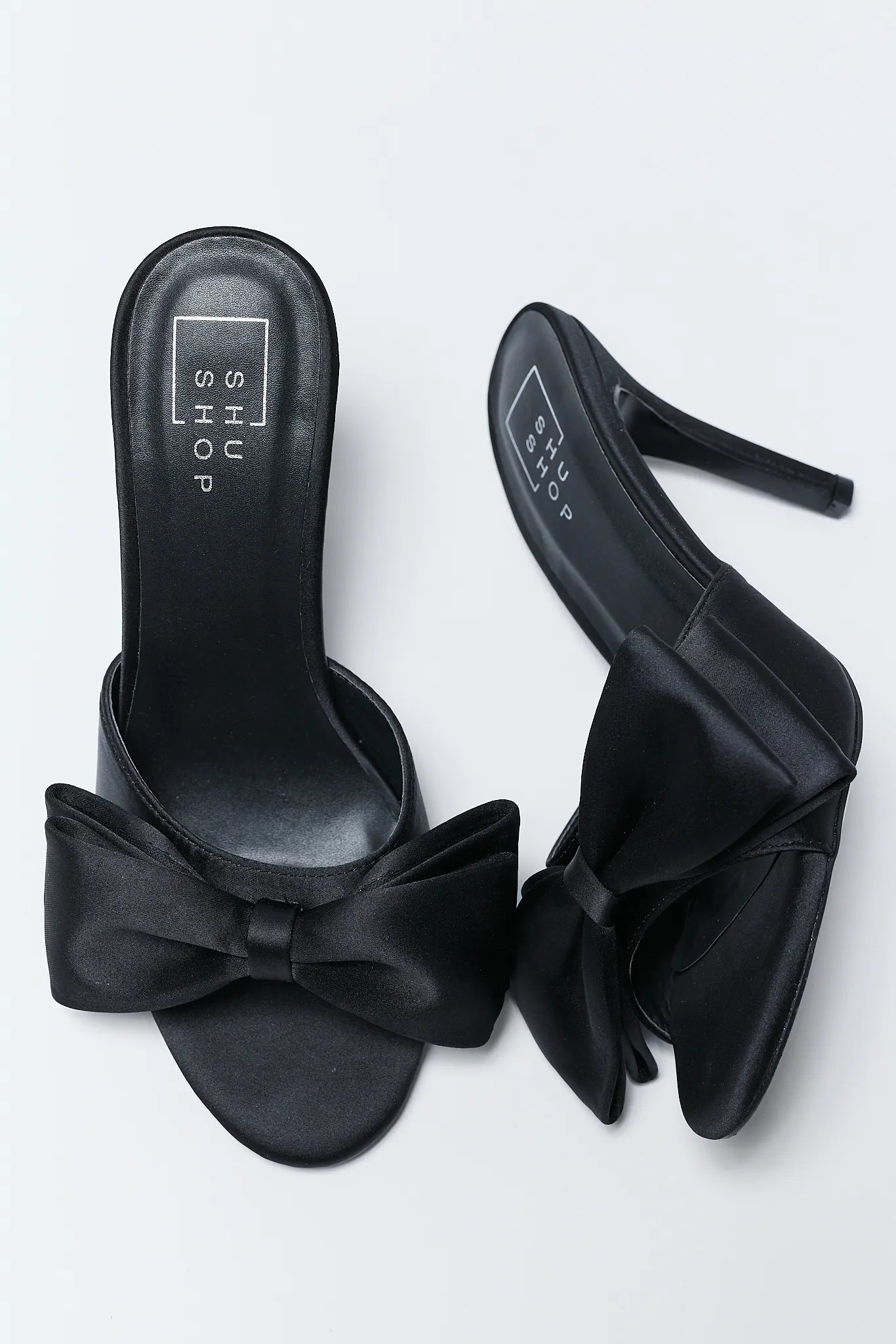 Elena Black Bow Heels with bow details on a light gray background