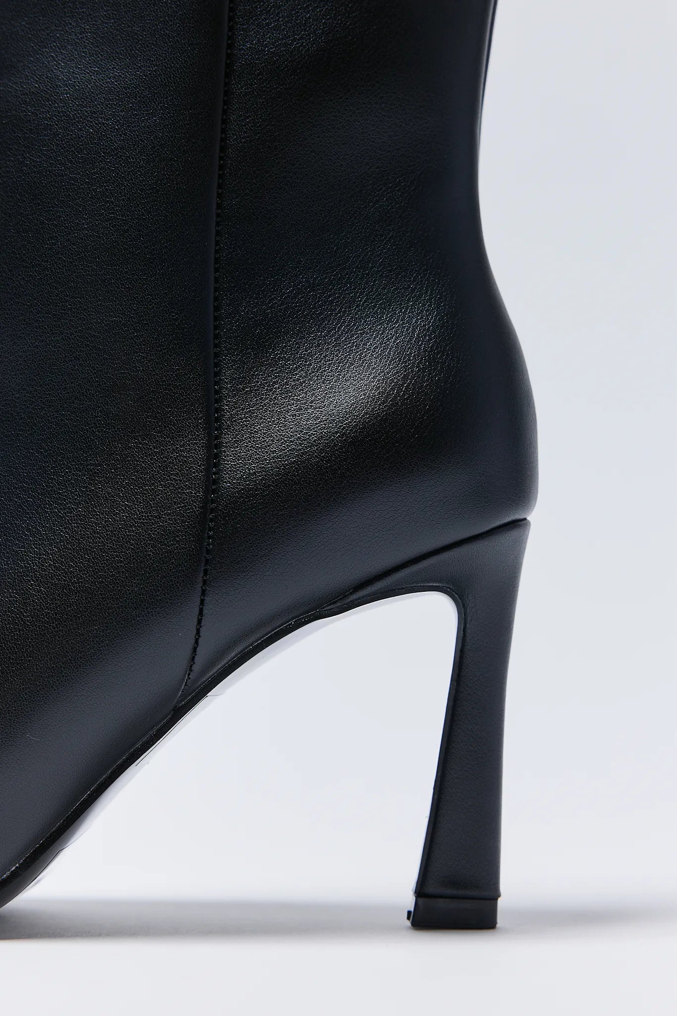 Black leather ankle Emery Boots with a high heel on a white background