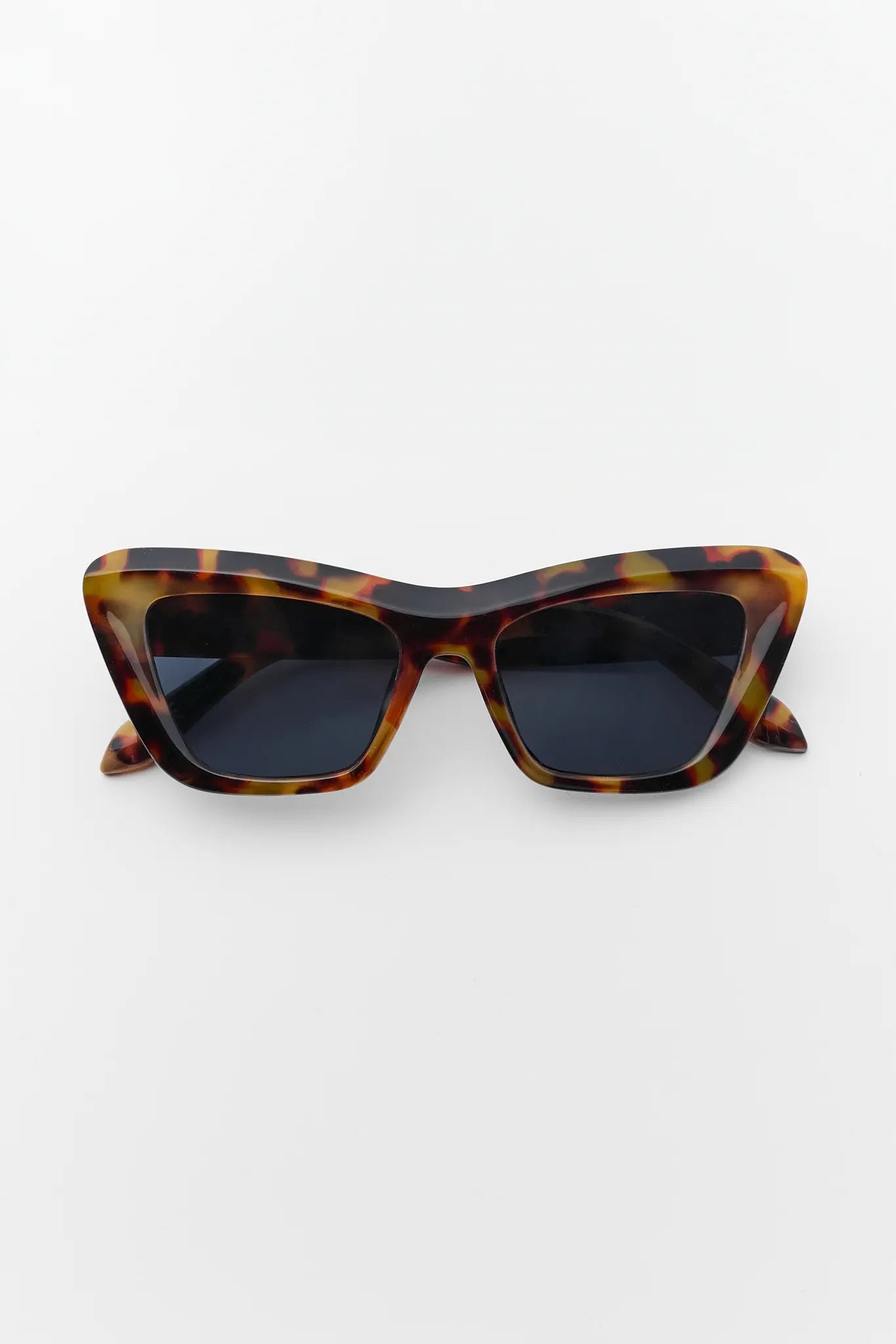 Tortoiseshell cat-eye sunglasses on a white background