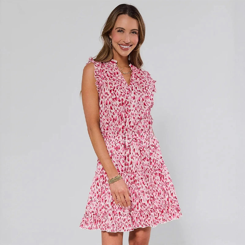 Woman wearing a pink floral dress against a gray background