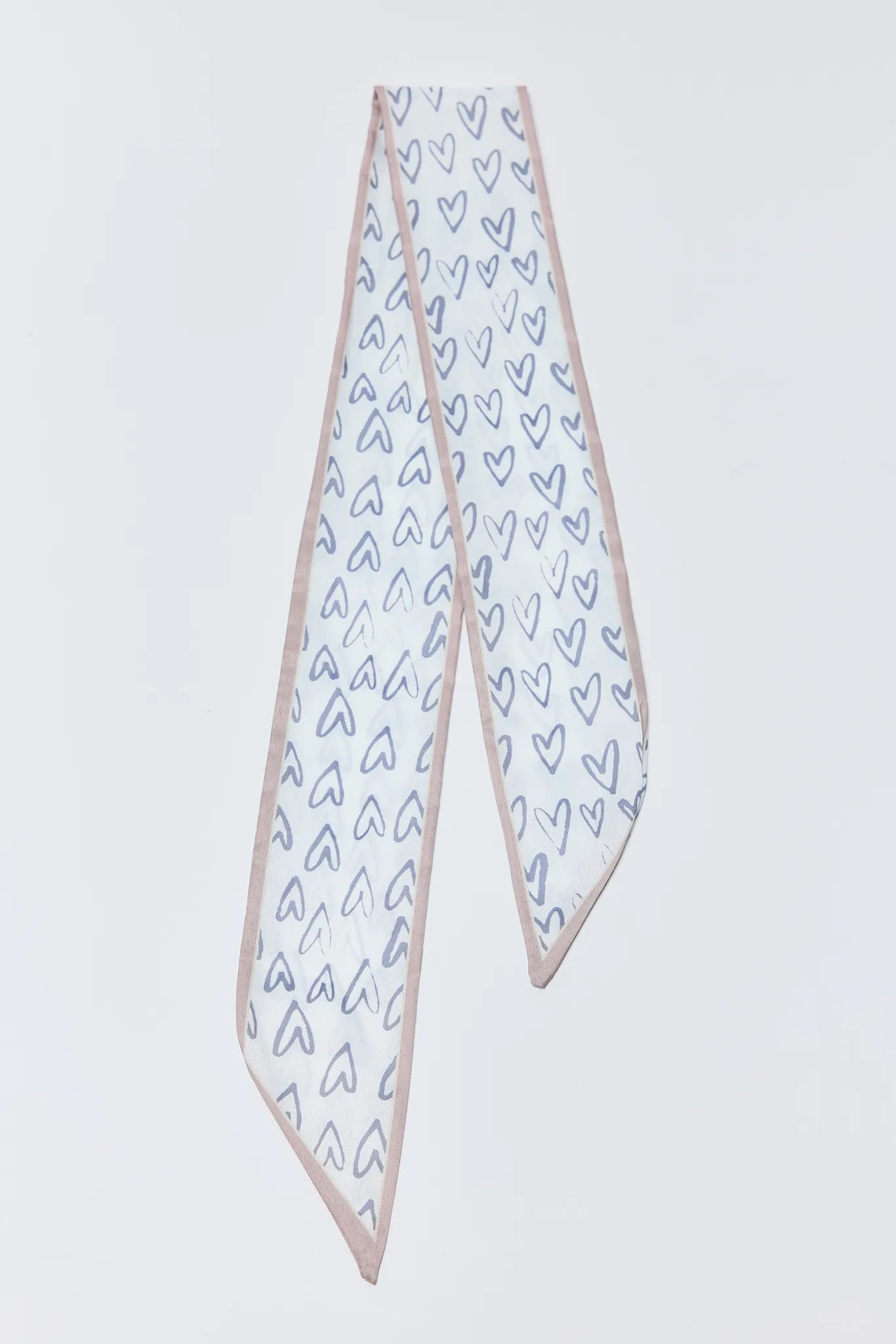 Freya Scarf with heart patterns on a light gray background