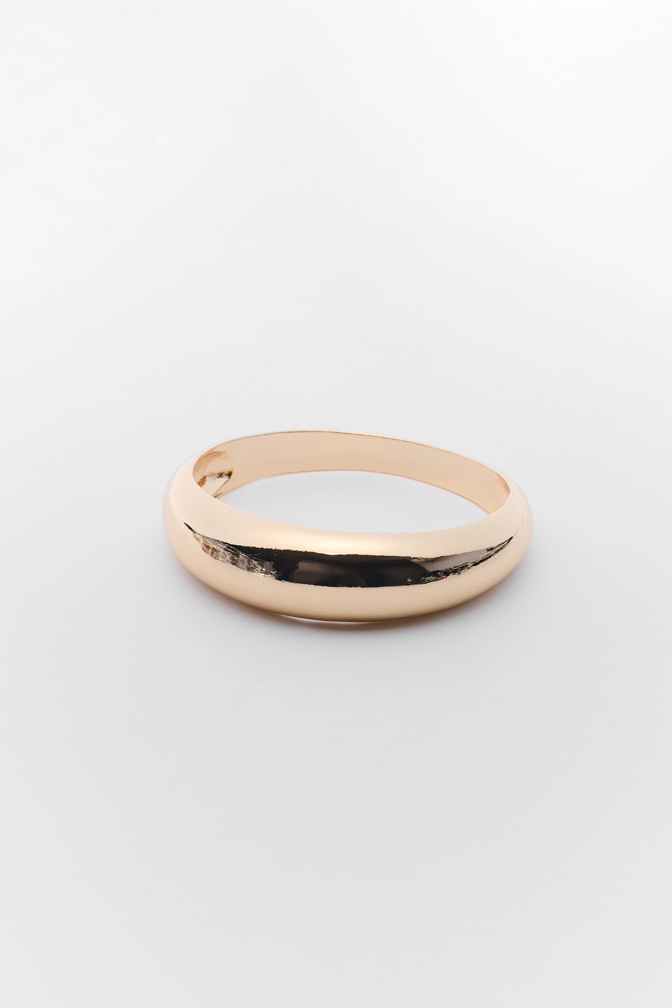 Rose gold bracelet on a light gray background
