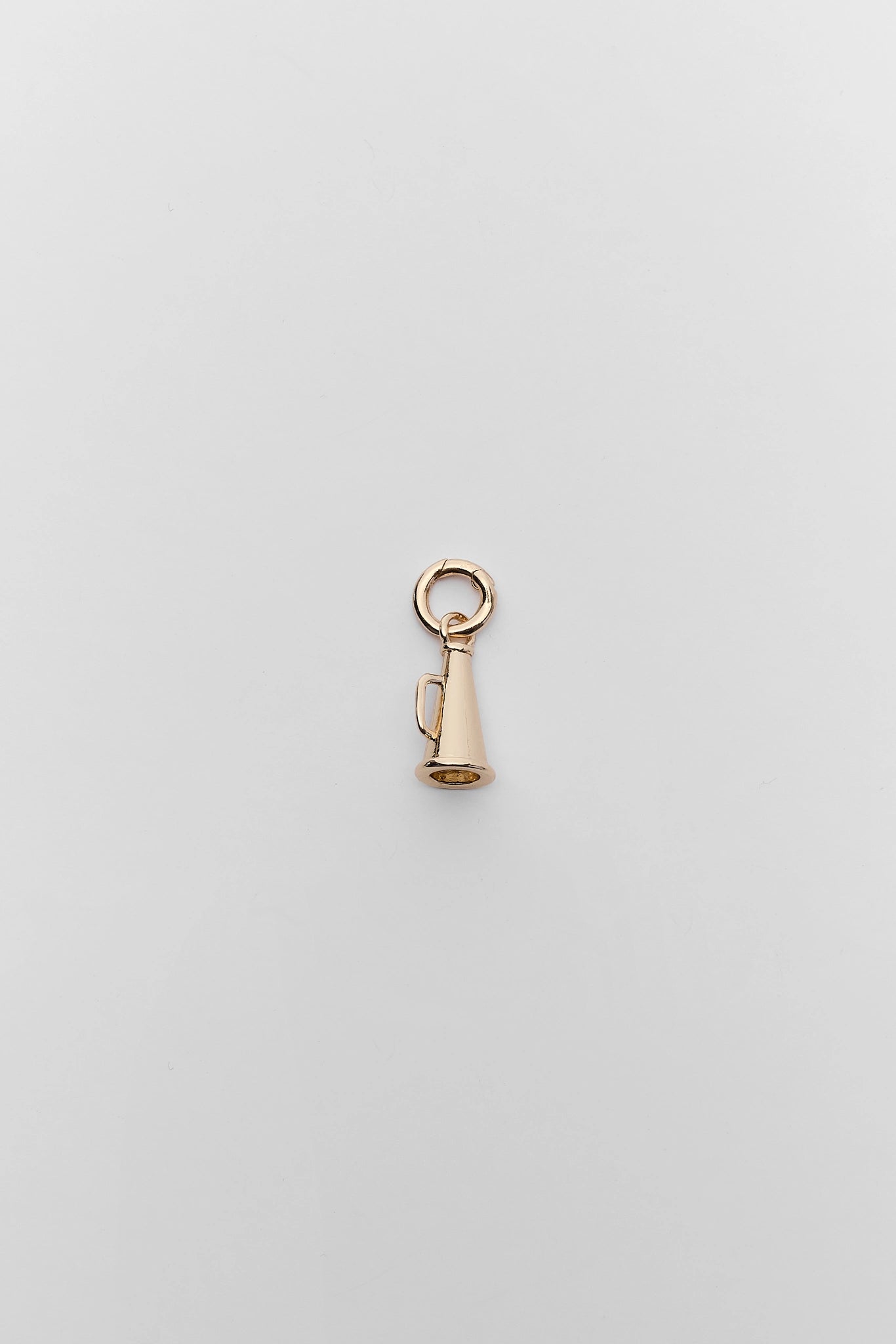 A gold megaphone charm with clasp, displayed on a neutral light gray background.