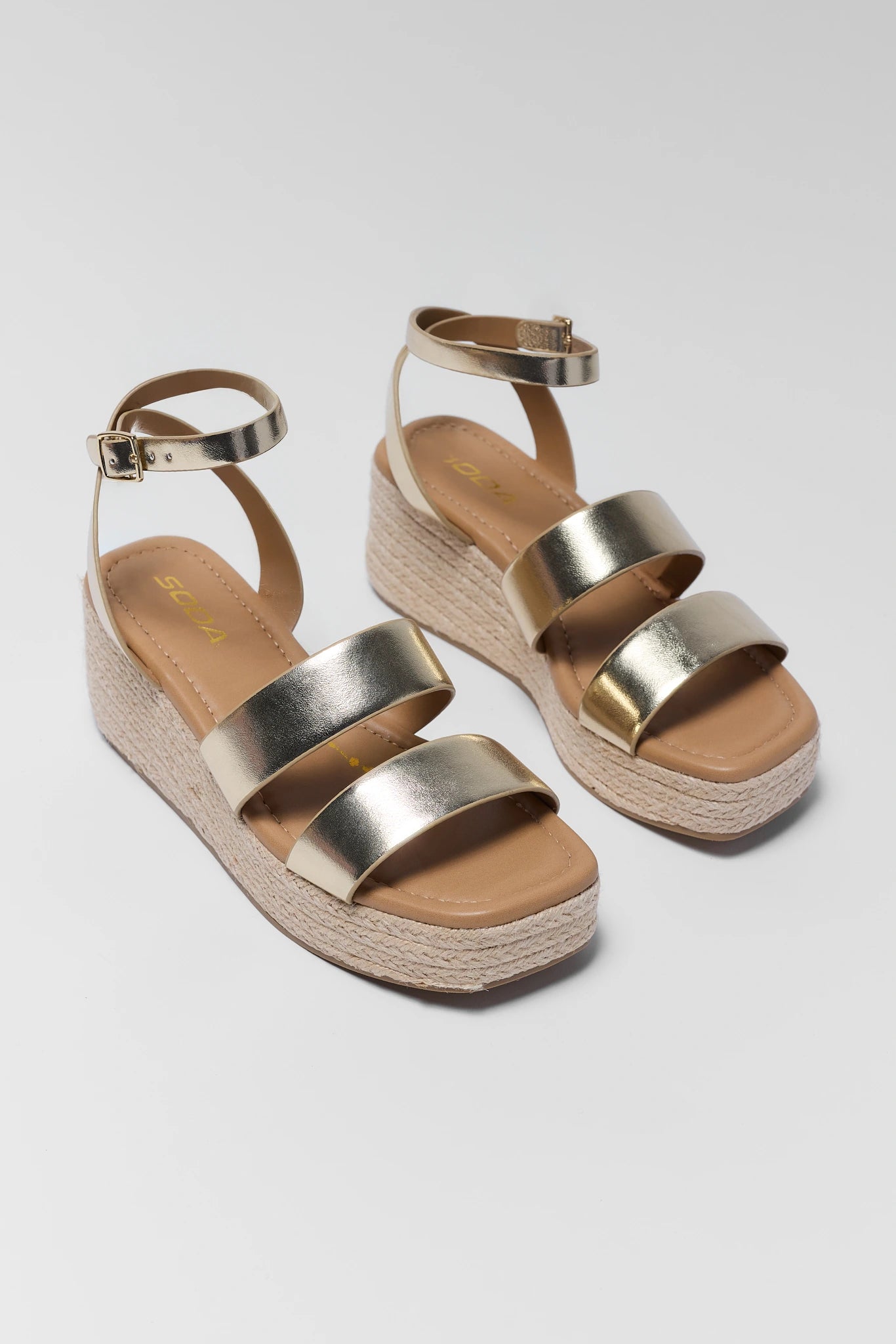 Gold platform sandals on a light gray background two 