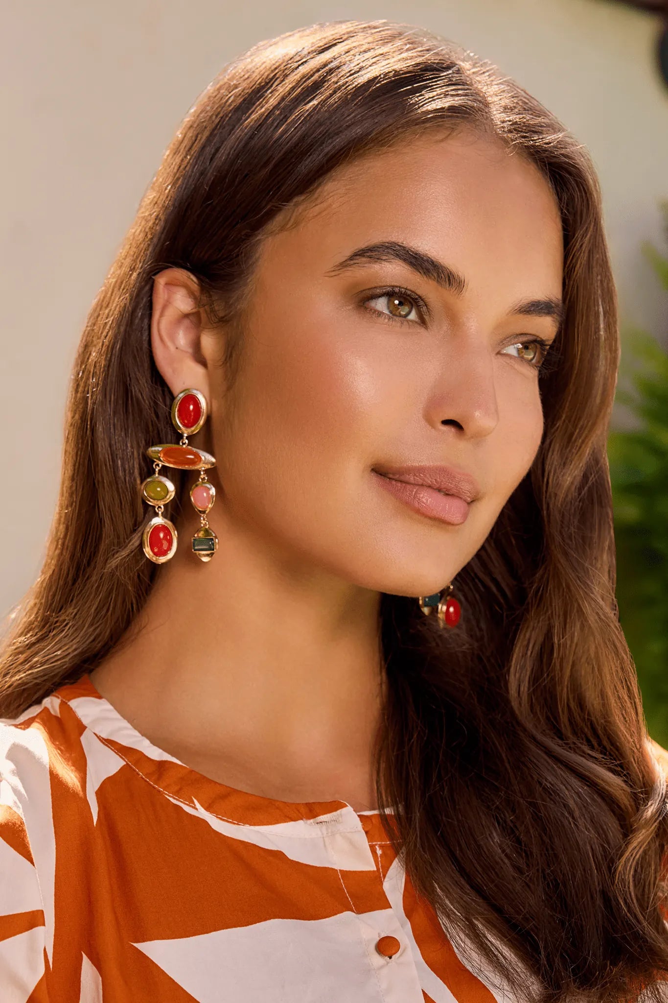 Woman wearing colorful drop earrings outdoors