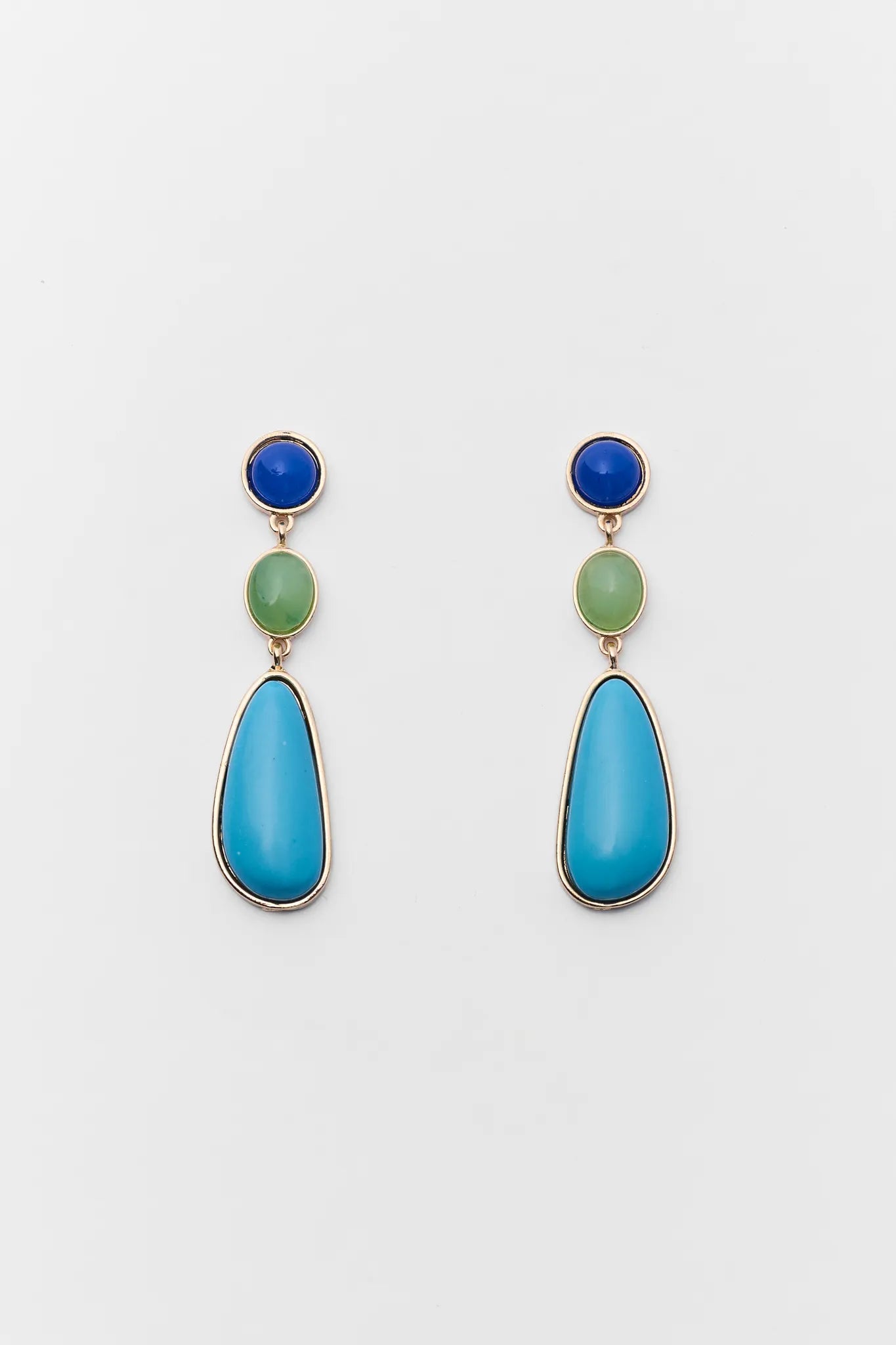 Pair of earrings with blue and green stones on a white background