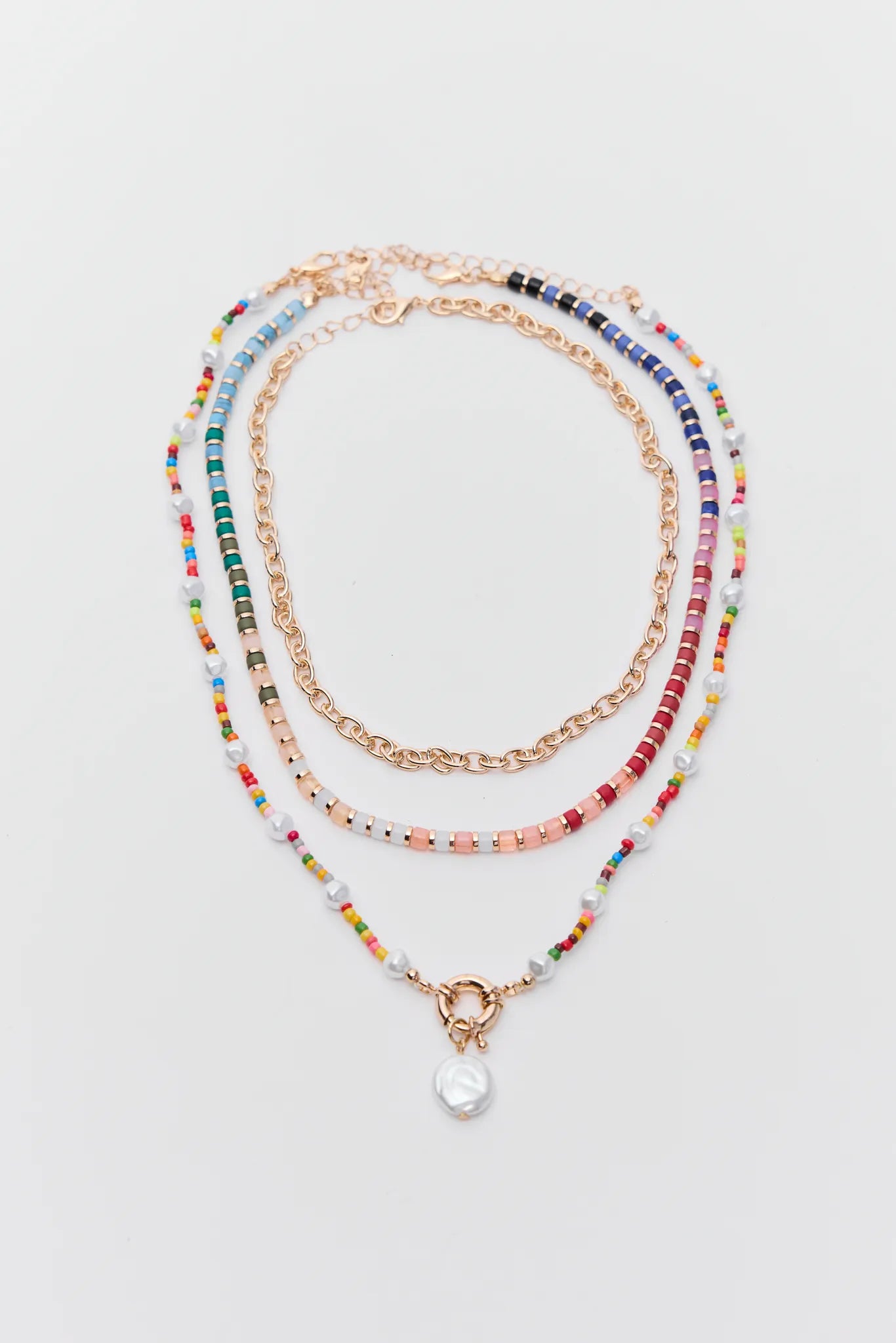 Set of multicolored beaded necklaces on a light gray background