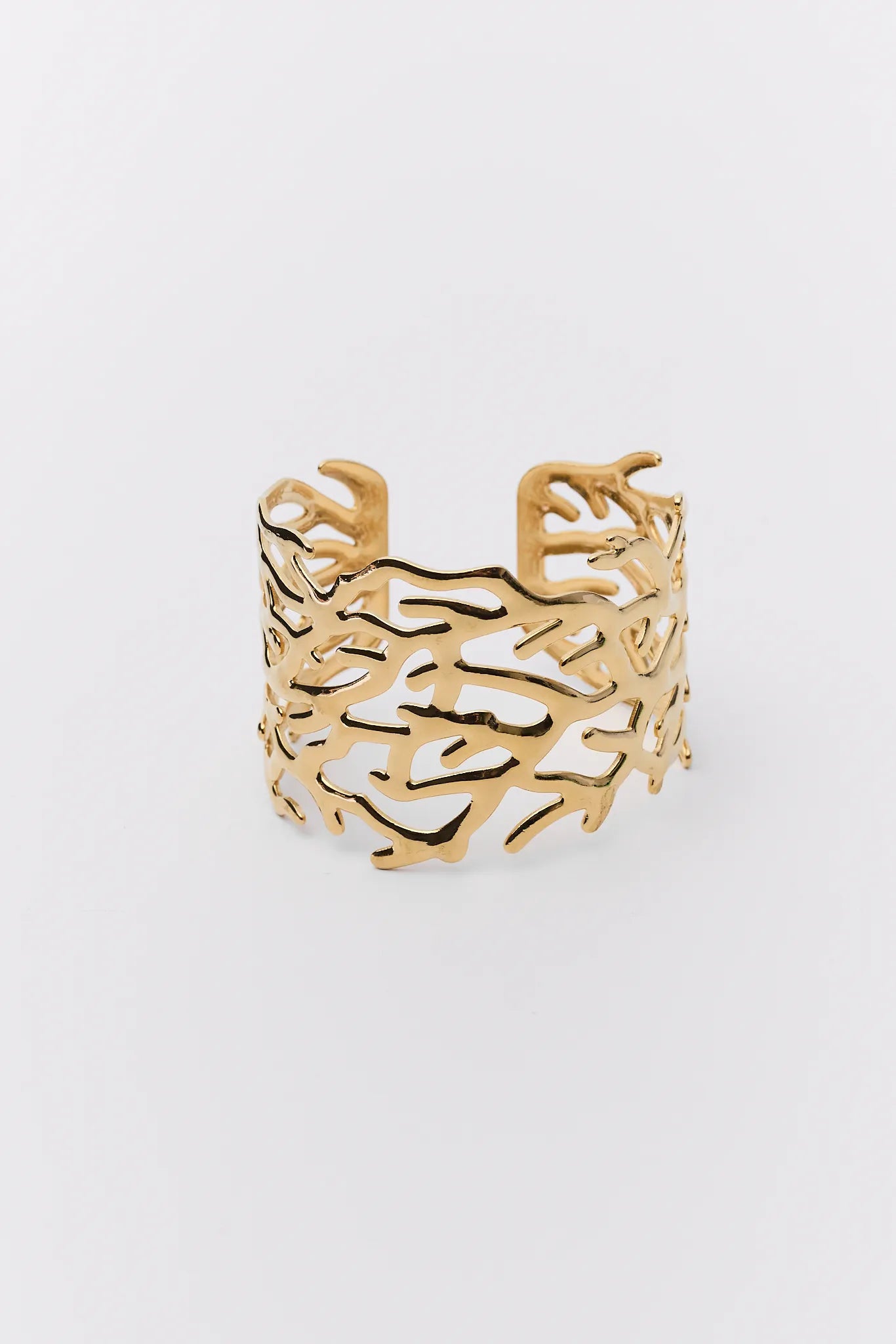 Gold bracelet with intricate design on a white background