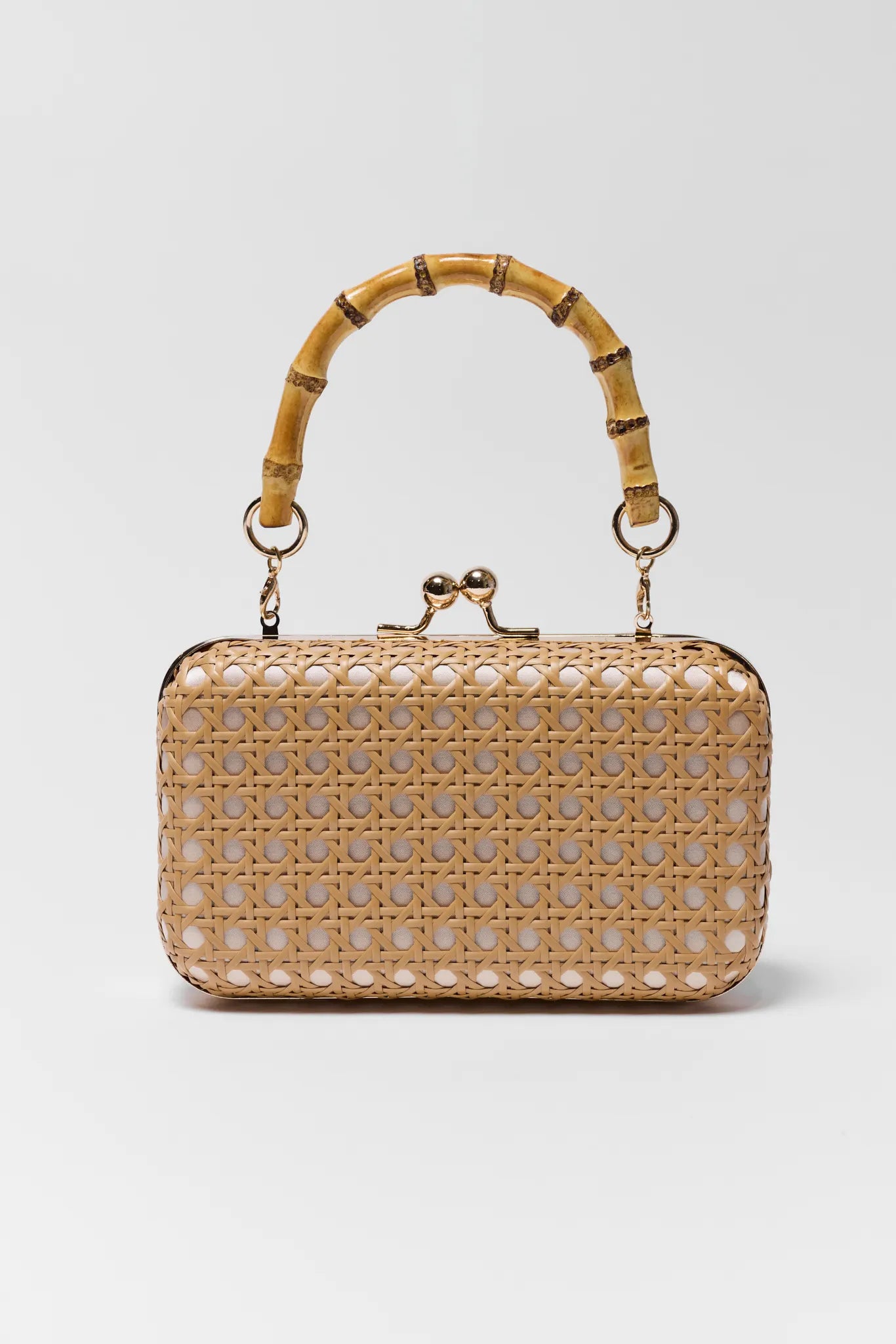Woven handbag with bamboo handle on a light gray background