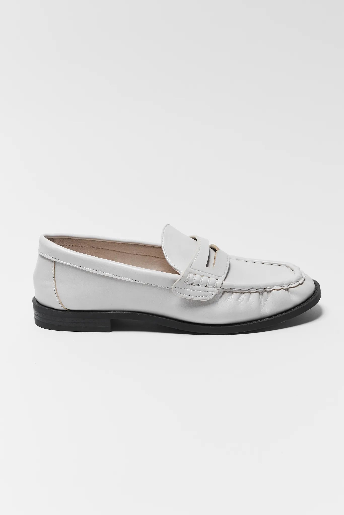 Sideways shot of Jacklyn Cream Faux Leather Loafer on a white background