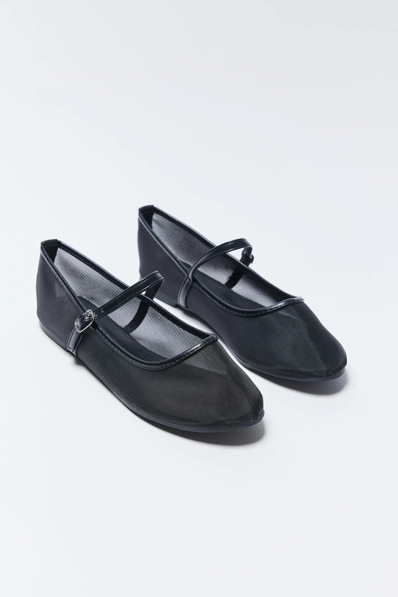 Pair of black Jane Flats with a strap on a white background