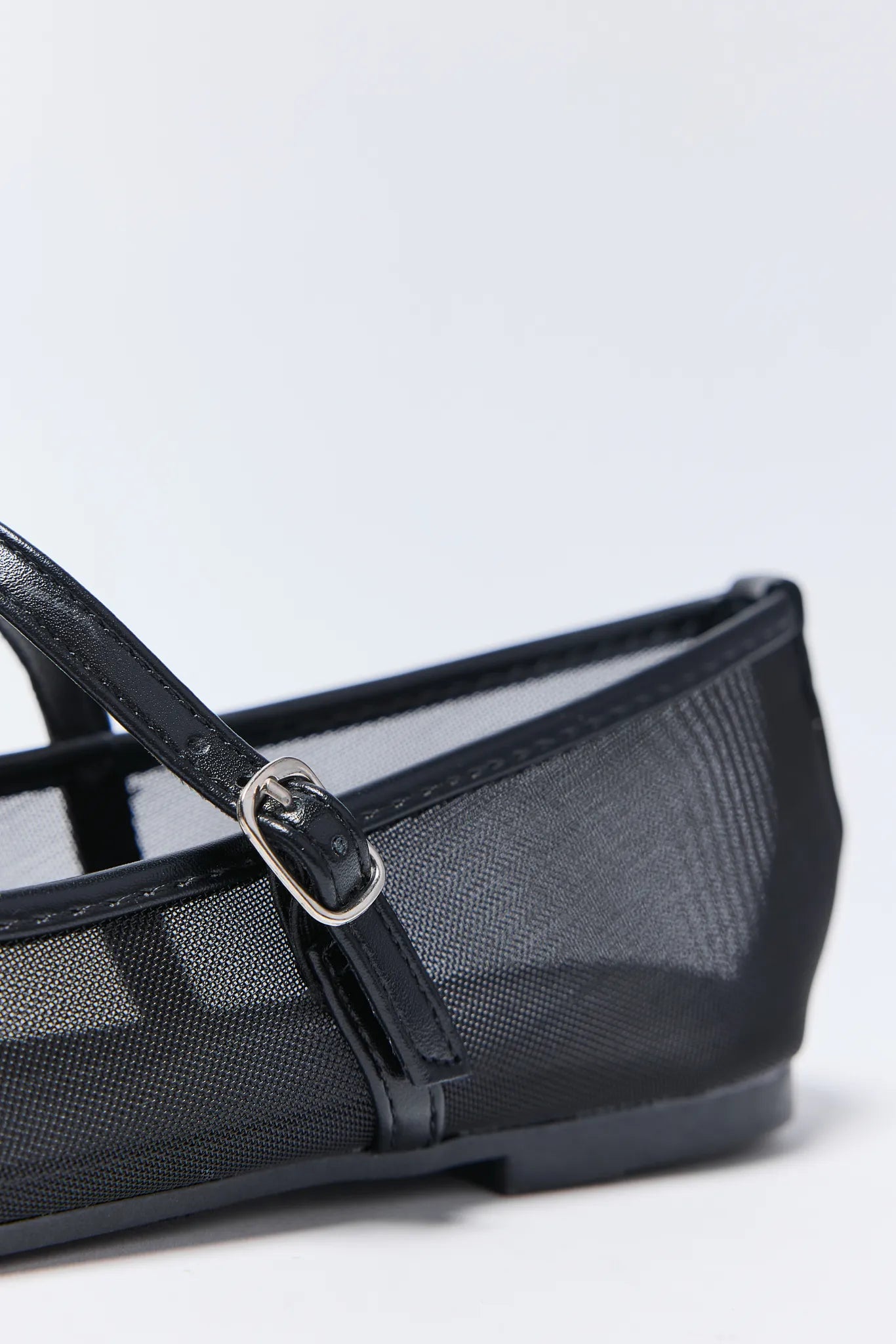 Black mesh ballerina Jane Flats with a strap on a light gray background