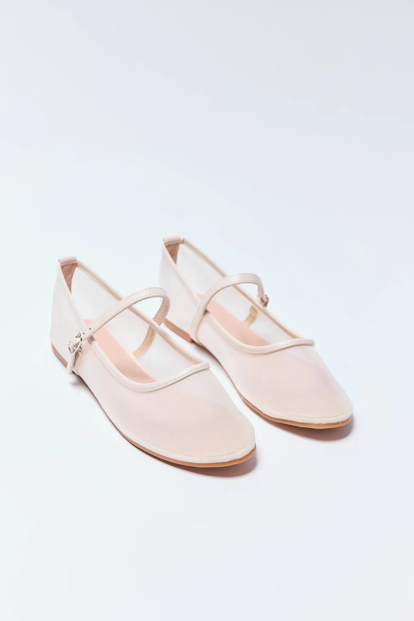 Pair of light pink Jane Flats on a white background