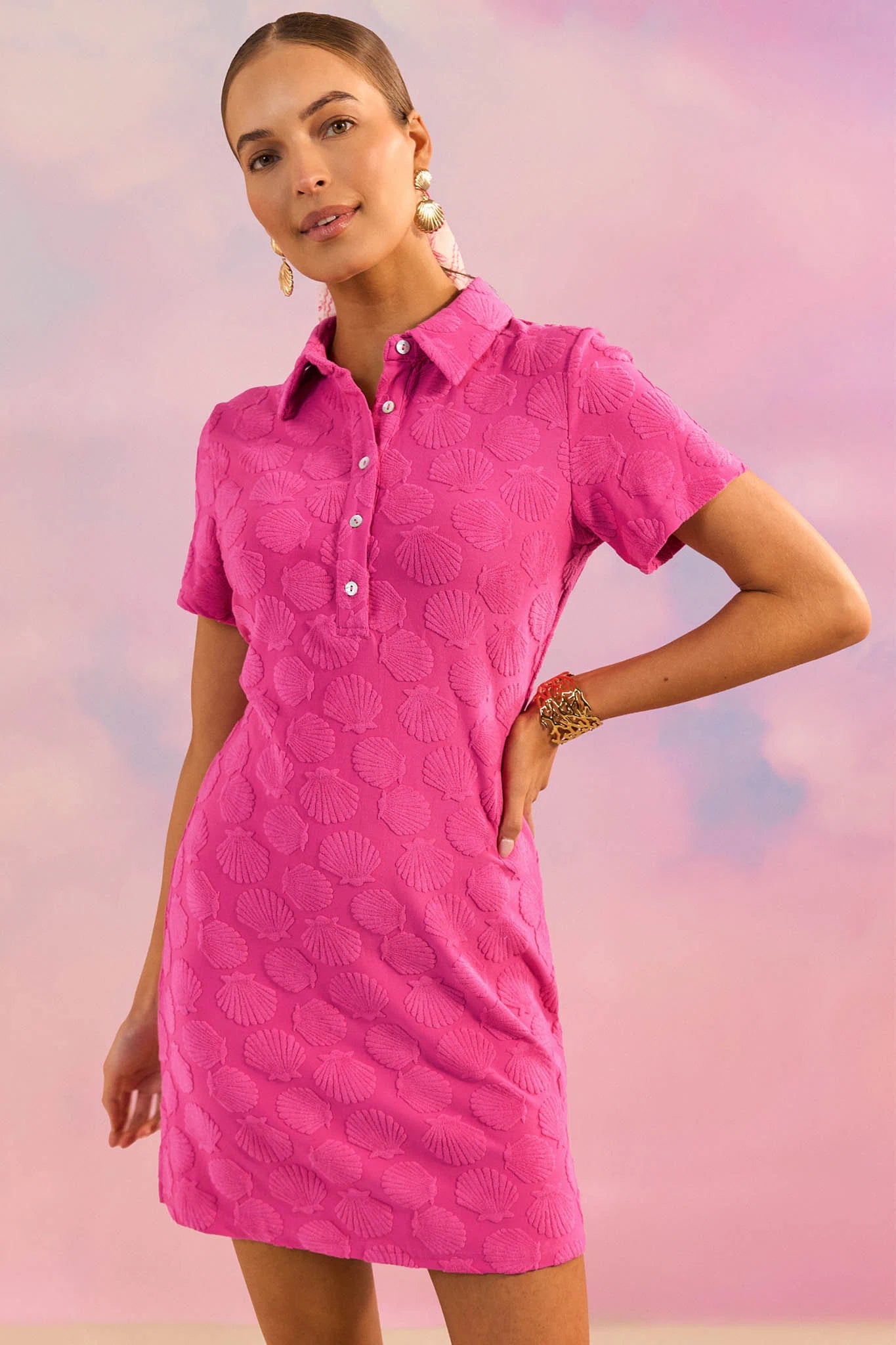 Woman wearing a pink dress against a pastel gradient background