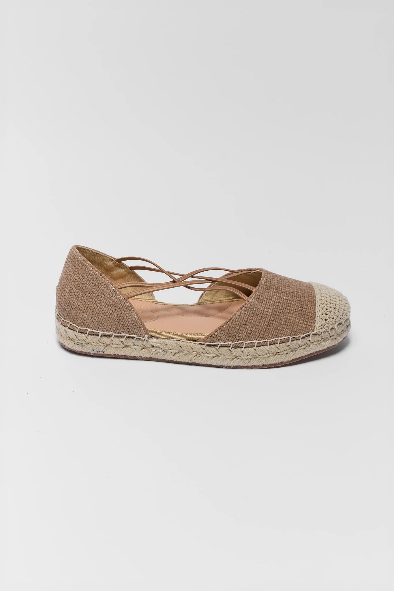 one Brown espadrille shoe on a light gray background