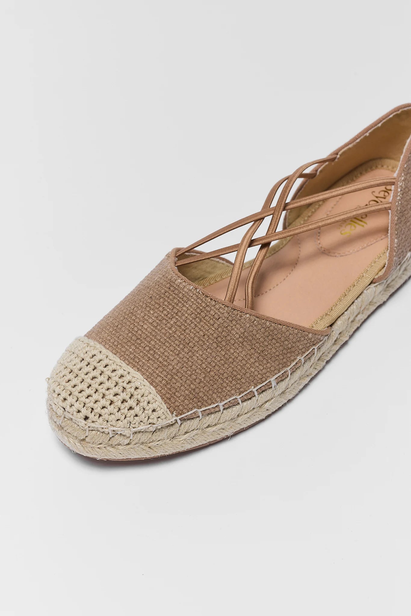 close up Brown espadrille shoe on a light gray background