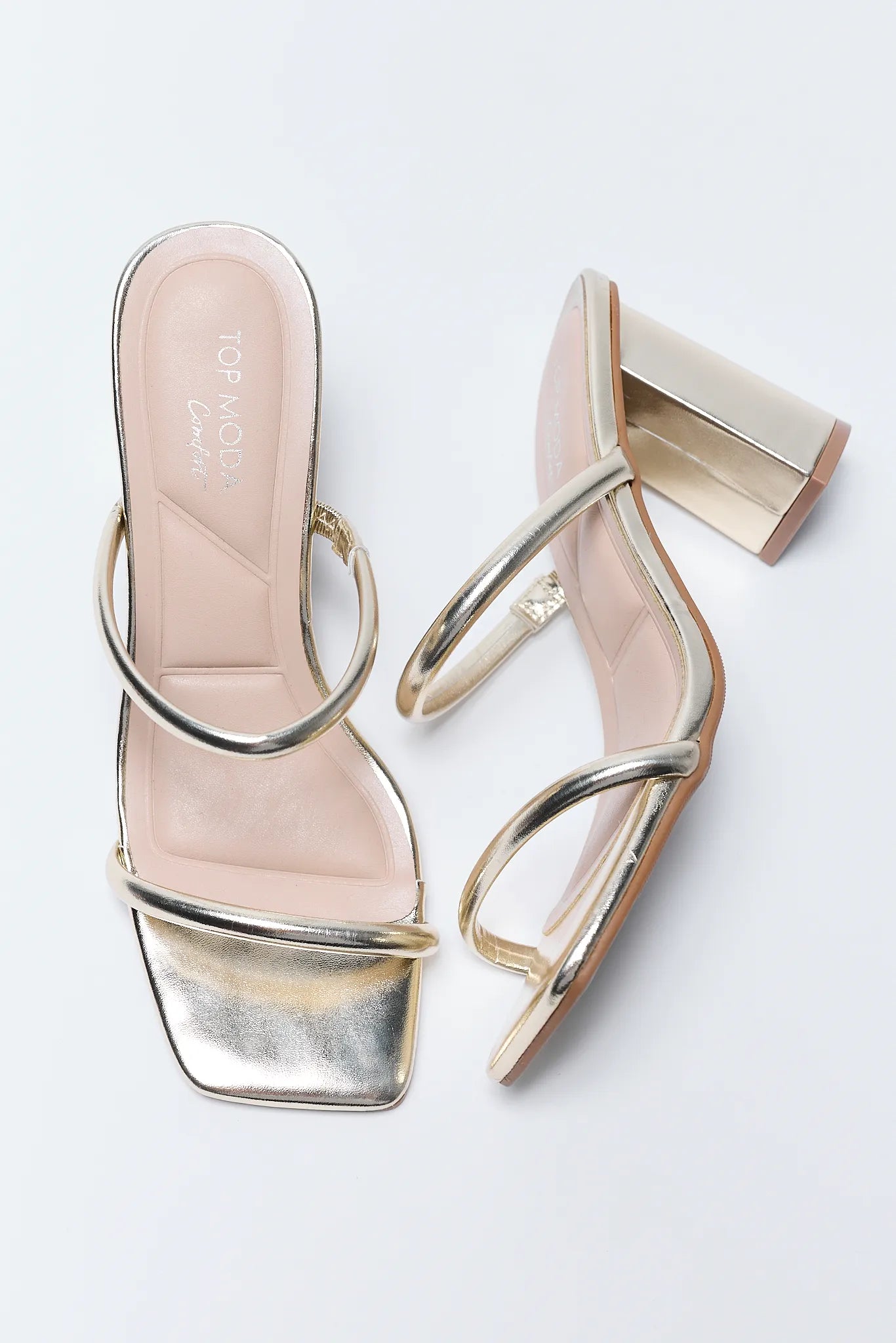 Pair of Kayce Gold Block Heels with metallic accents on a light background