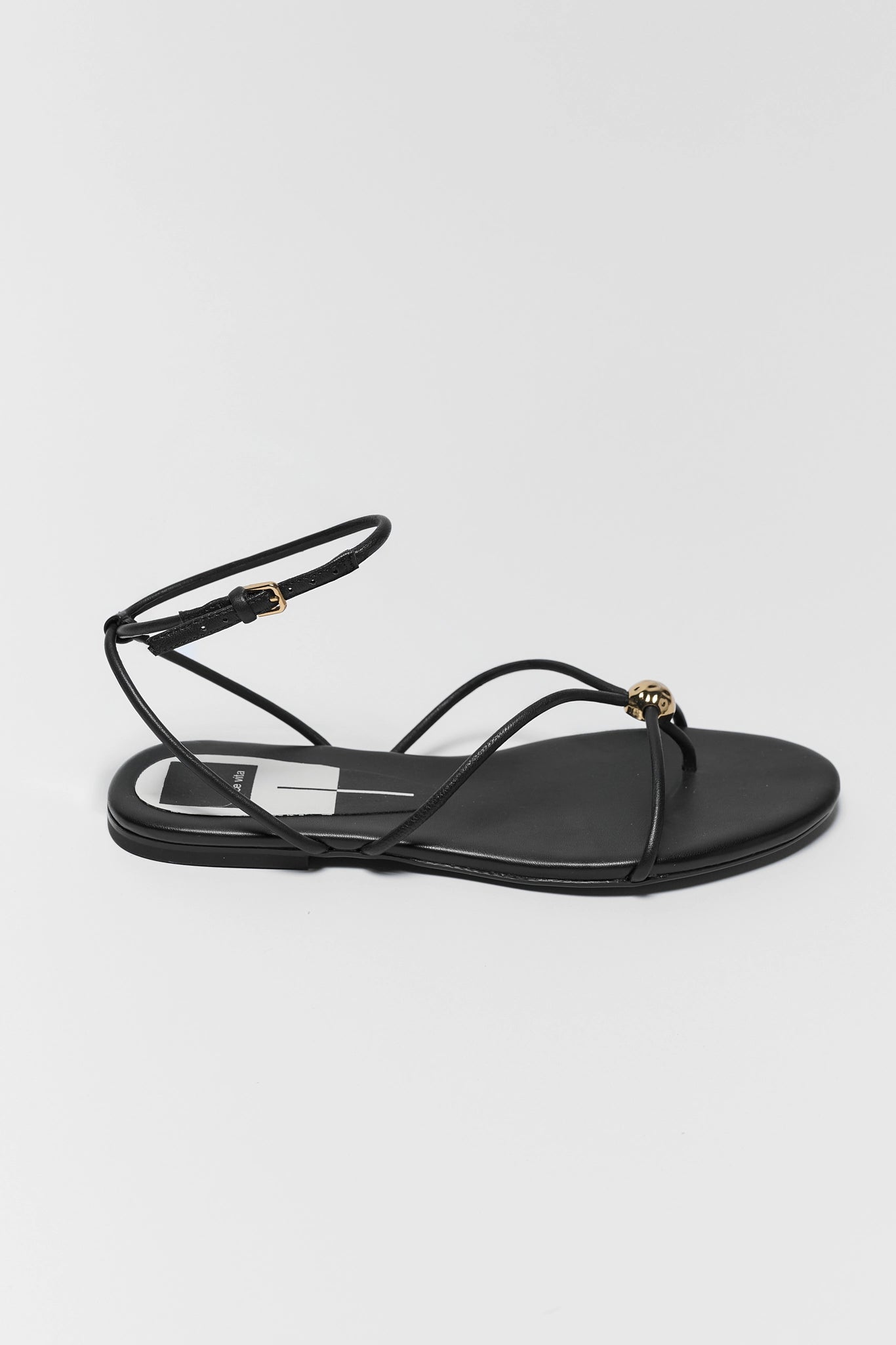 one Black sandal with thin straps on a white background