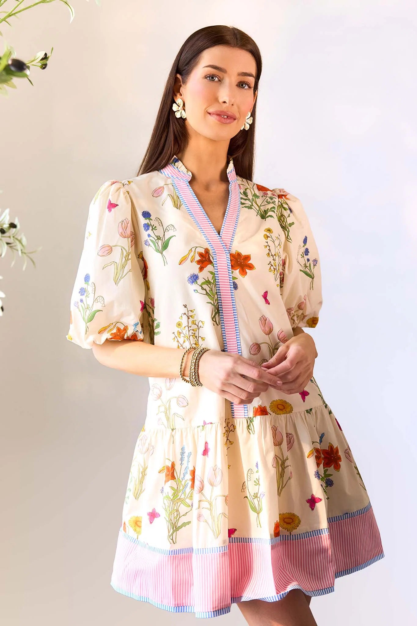 Woman wearing a floral dress with a neutral background
