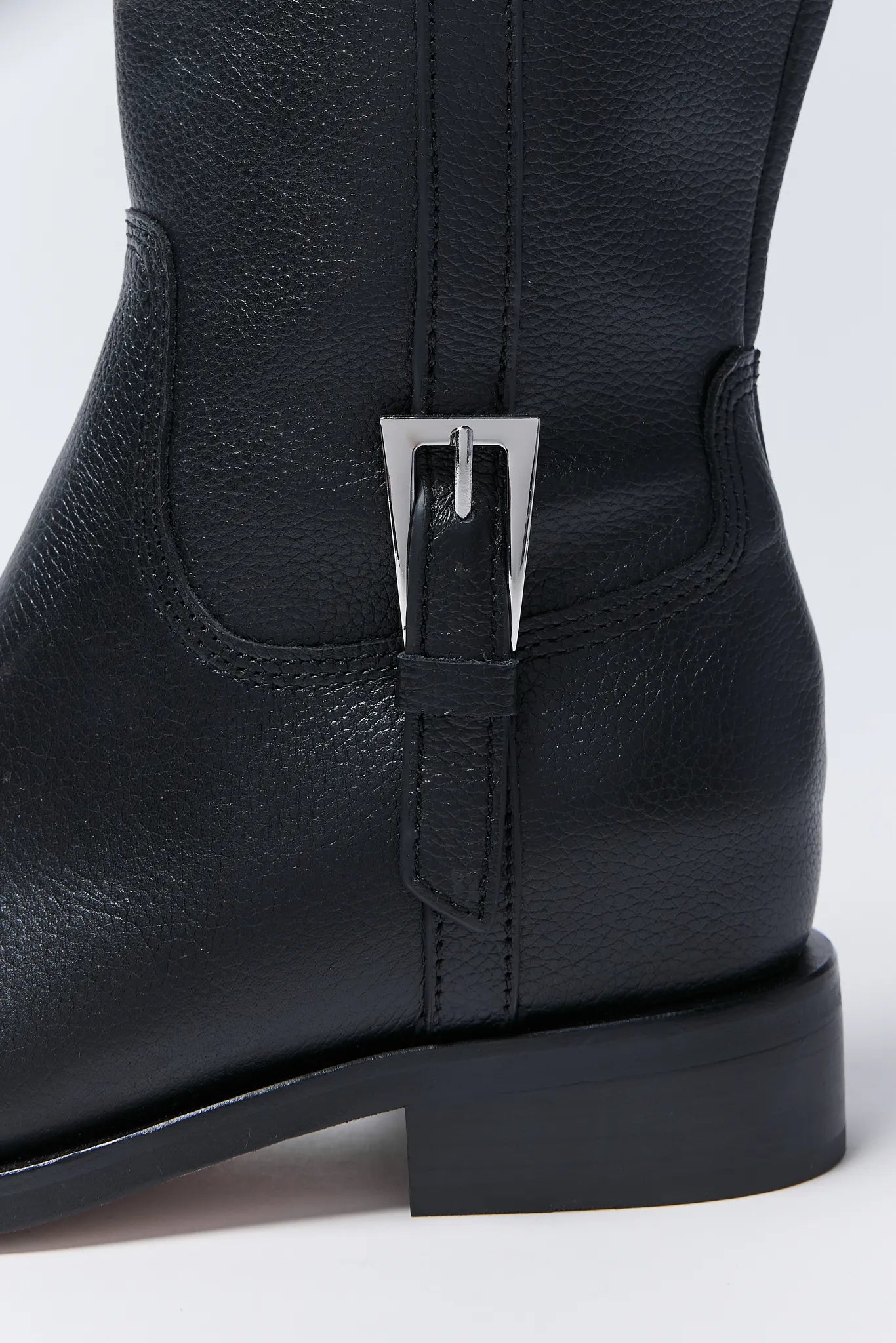 Black leather Kilian Boots with a silver buckle on a white background
