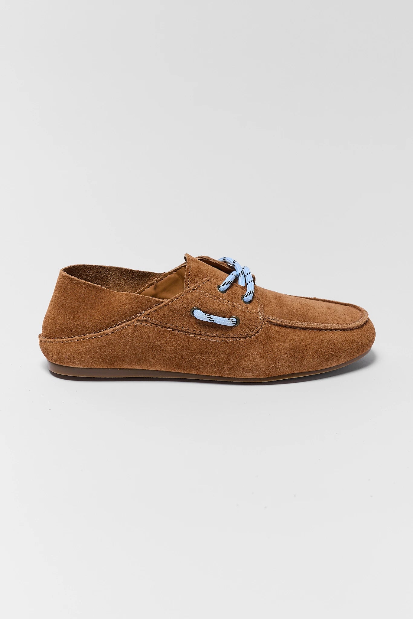 one Brown suede shoe with blue laces on a light gray background