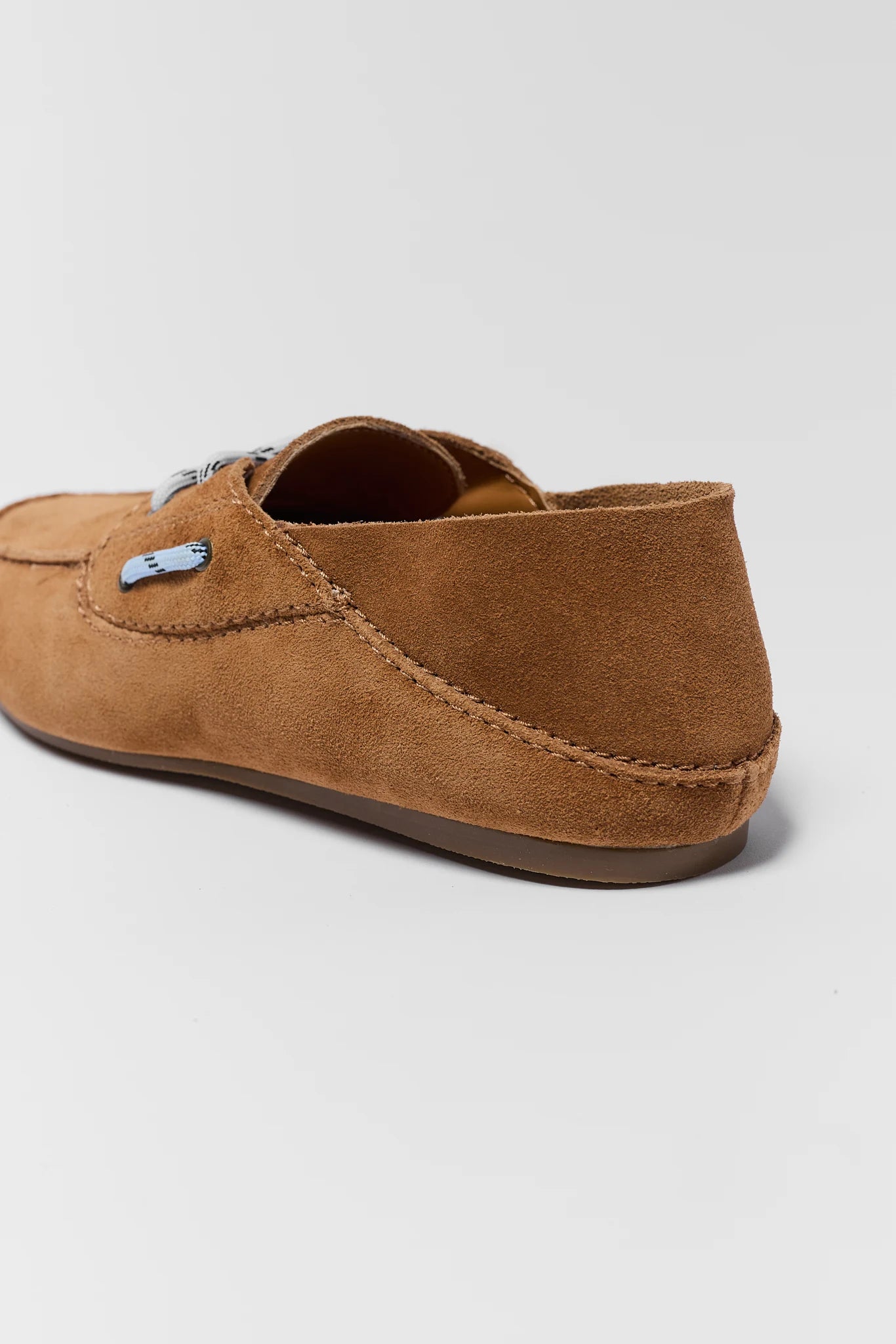 Brown suede loafer shoe on a light gray background back