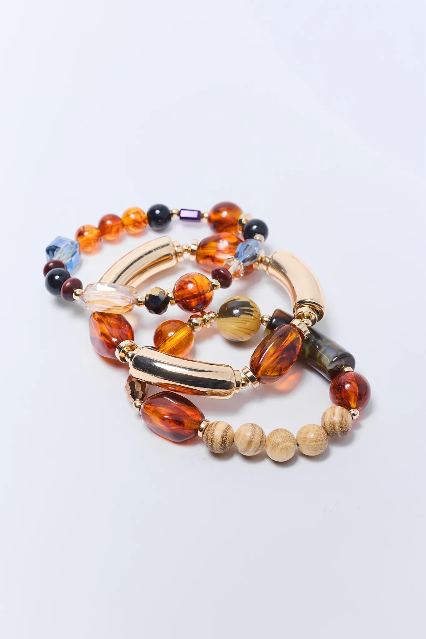 Multicolored beaded Lindsay Bracelet Set with gold accents on a light gray background