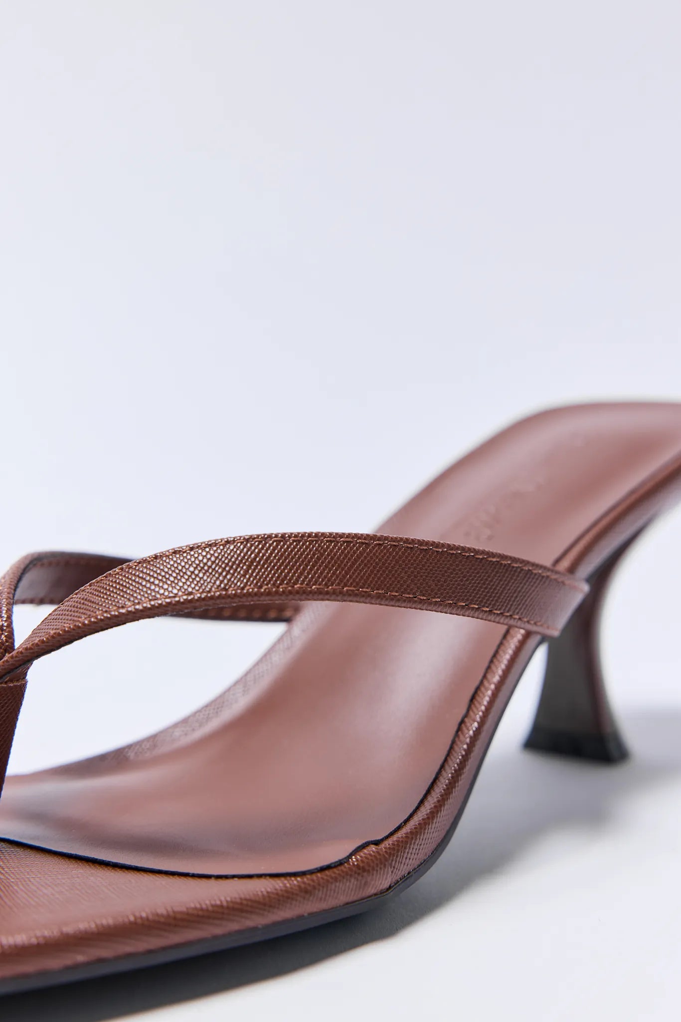 Brown high-heeled Lindy Heels on a light gray background