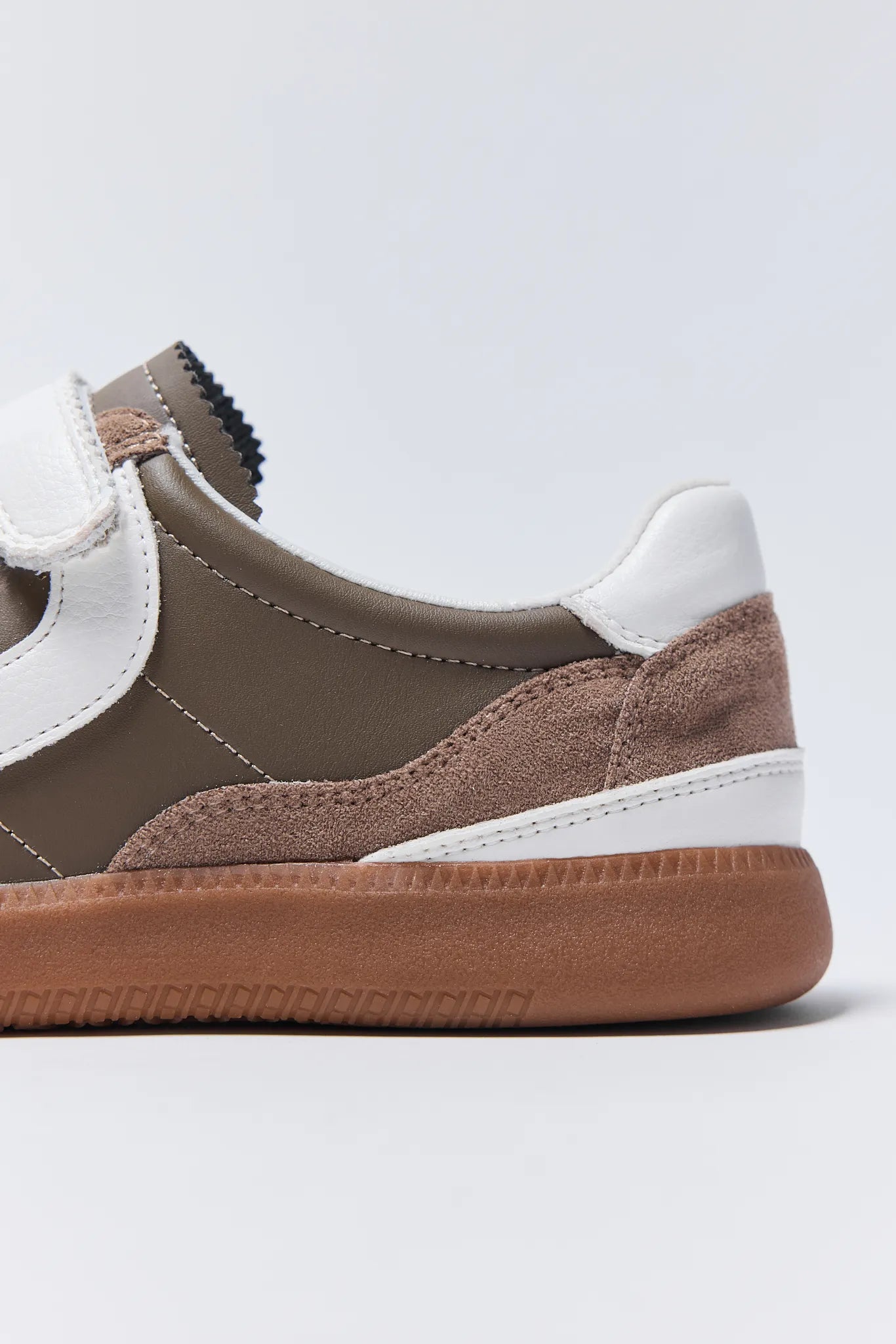 Brown and white Lizzie Sneakers on a light gray background