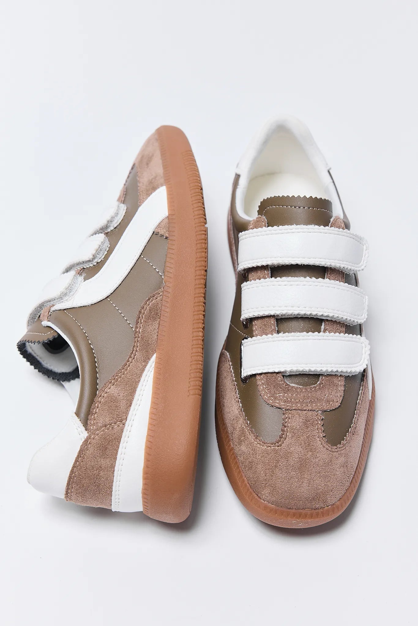 Pair of brown and white Lizzie Sneakers on a light gray background