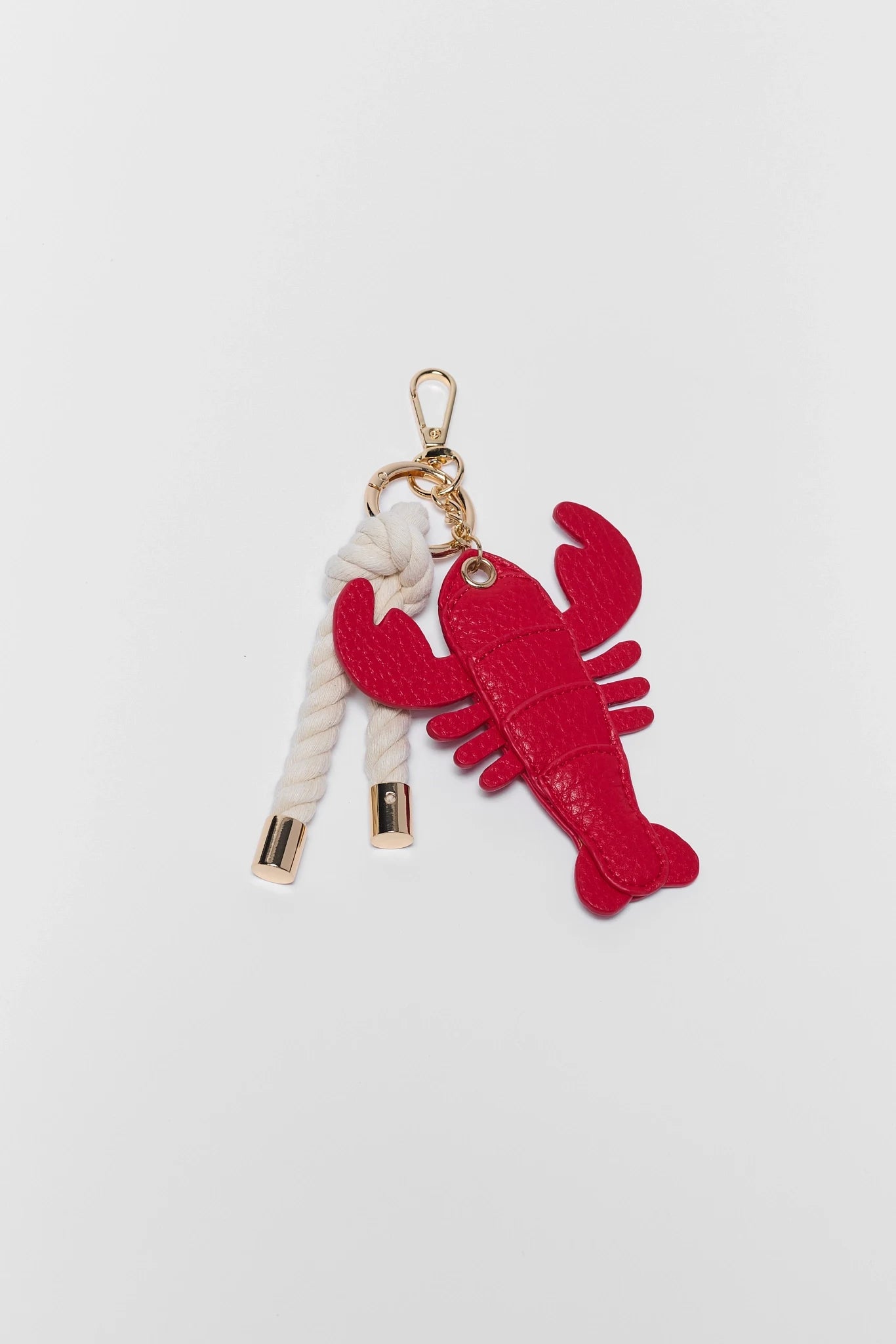 Red lobster keychain with a rope on a light gray background