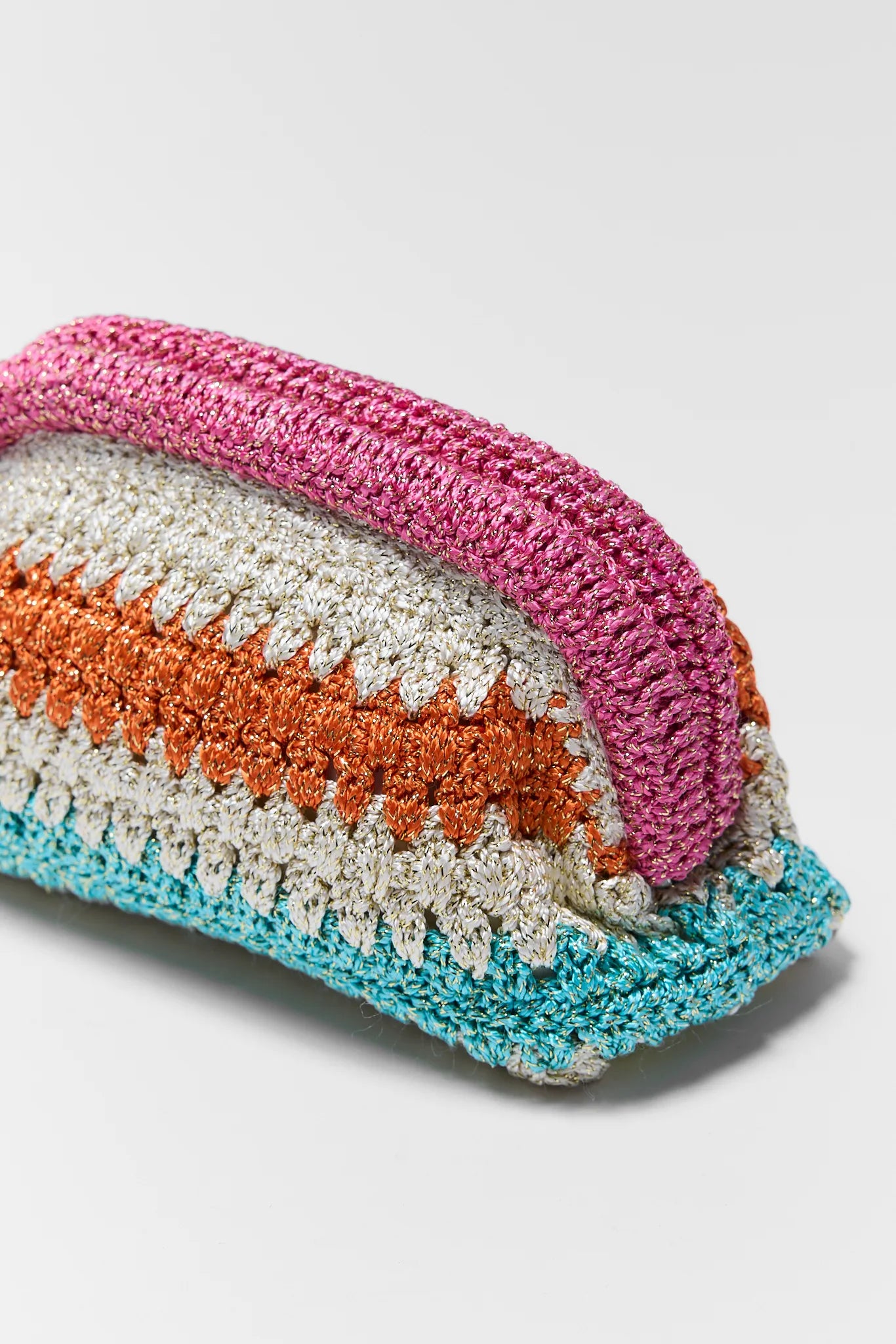 Colorful crochet pouch with pink, orange, and blue stripes on a light gray background