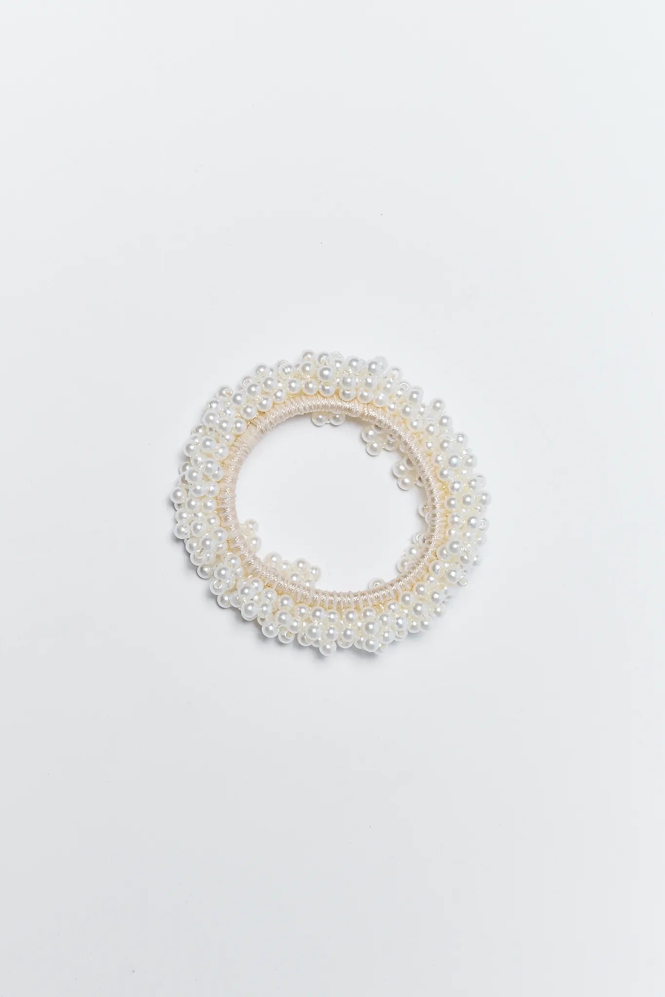 Pearl hair bun holder on a light gray background