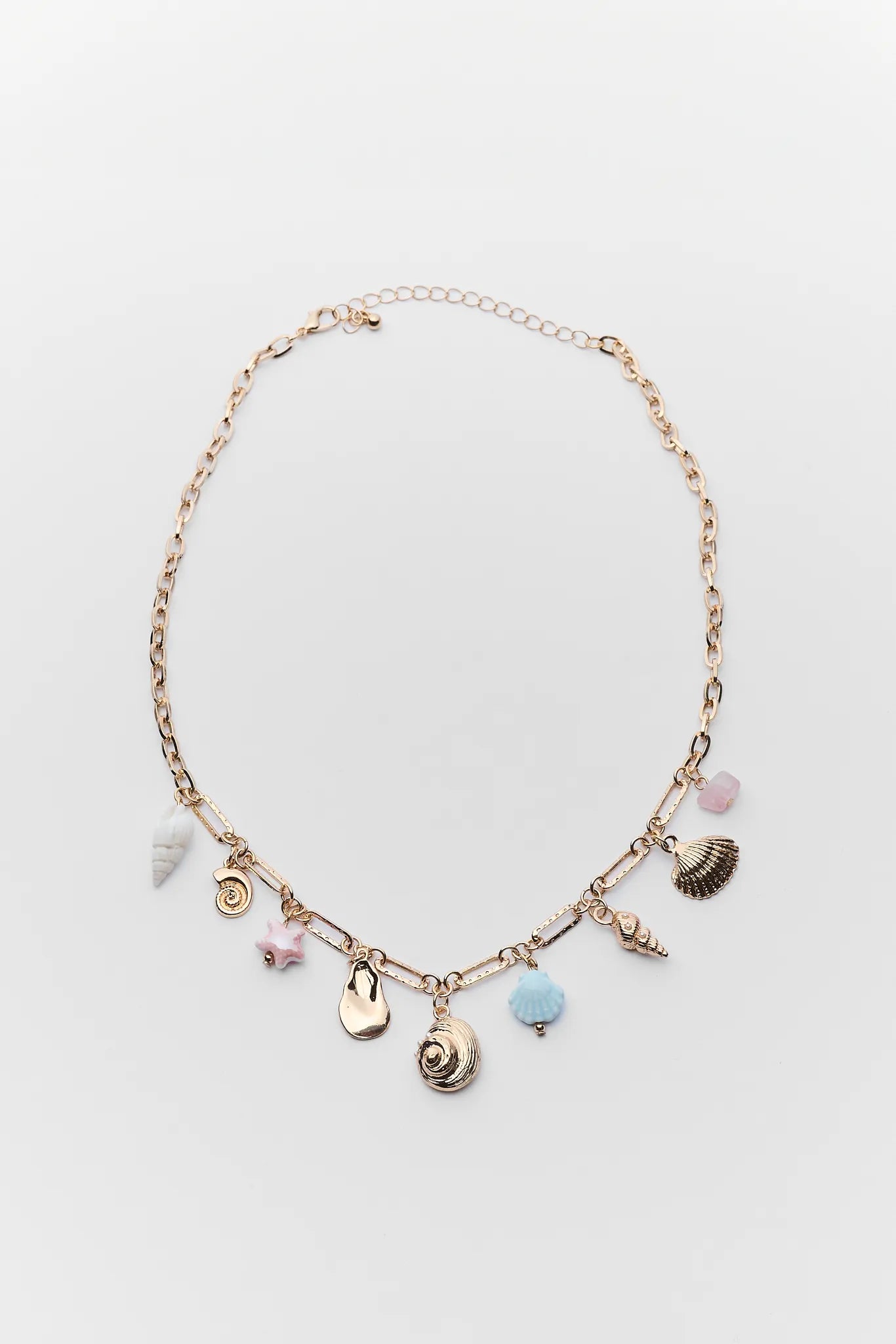 Necklace with various charms on a light gray background