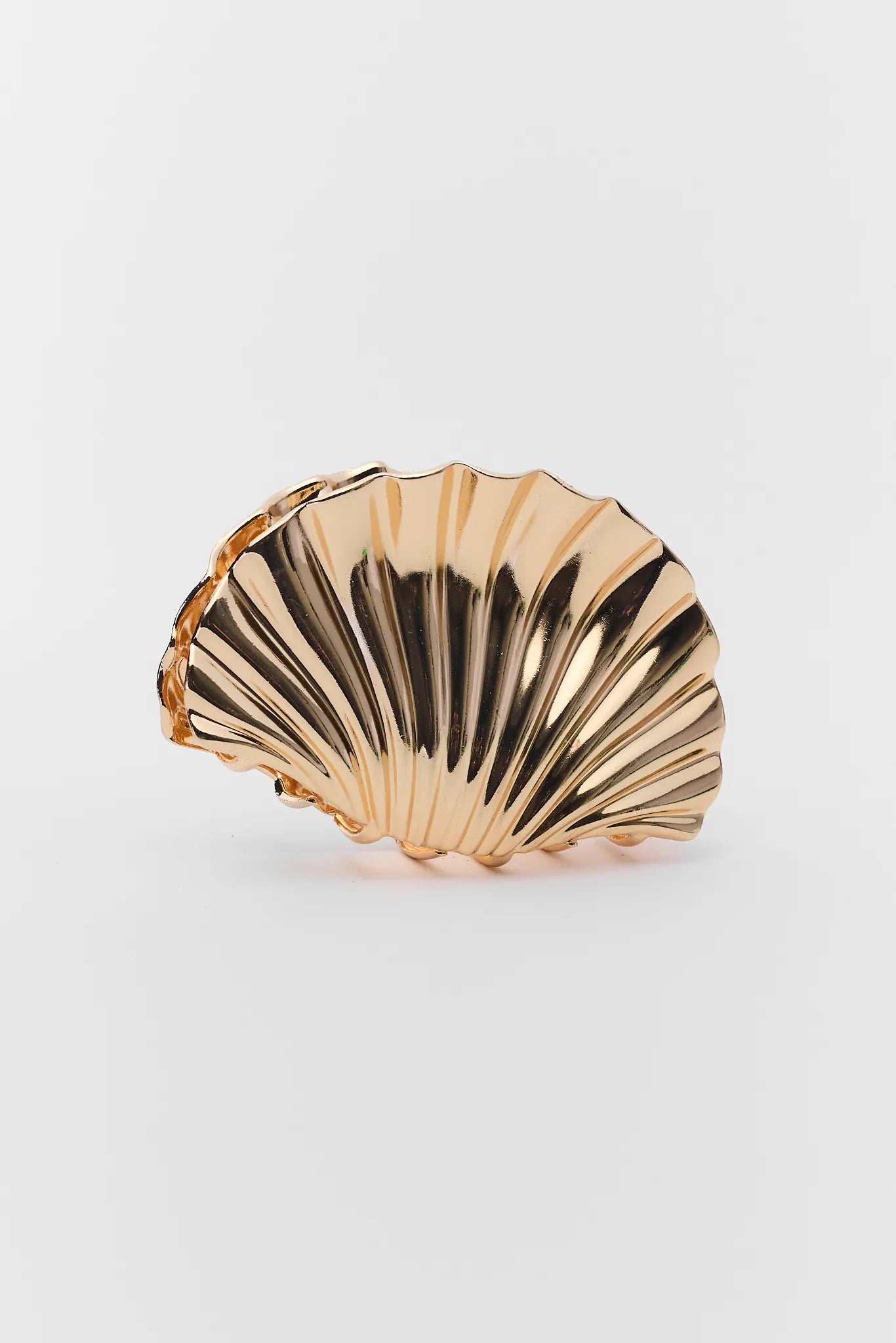 Gold shell-shaped object on a white background