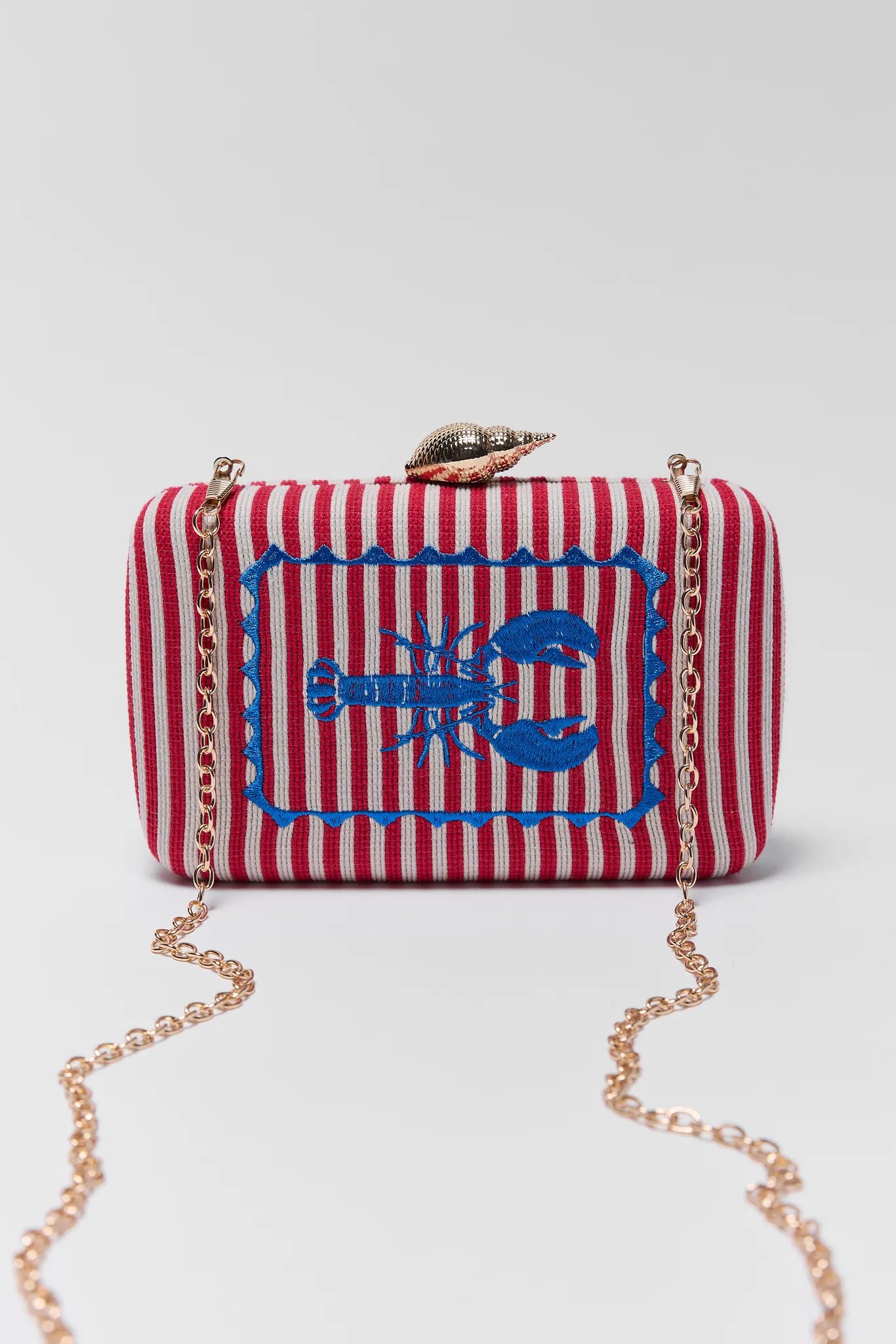 Red and white striped clutch bag with a blue lobster design on a white background