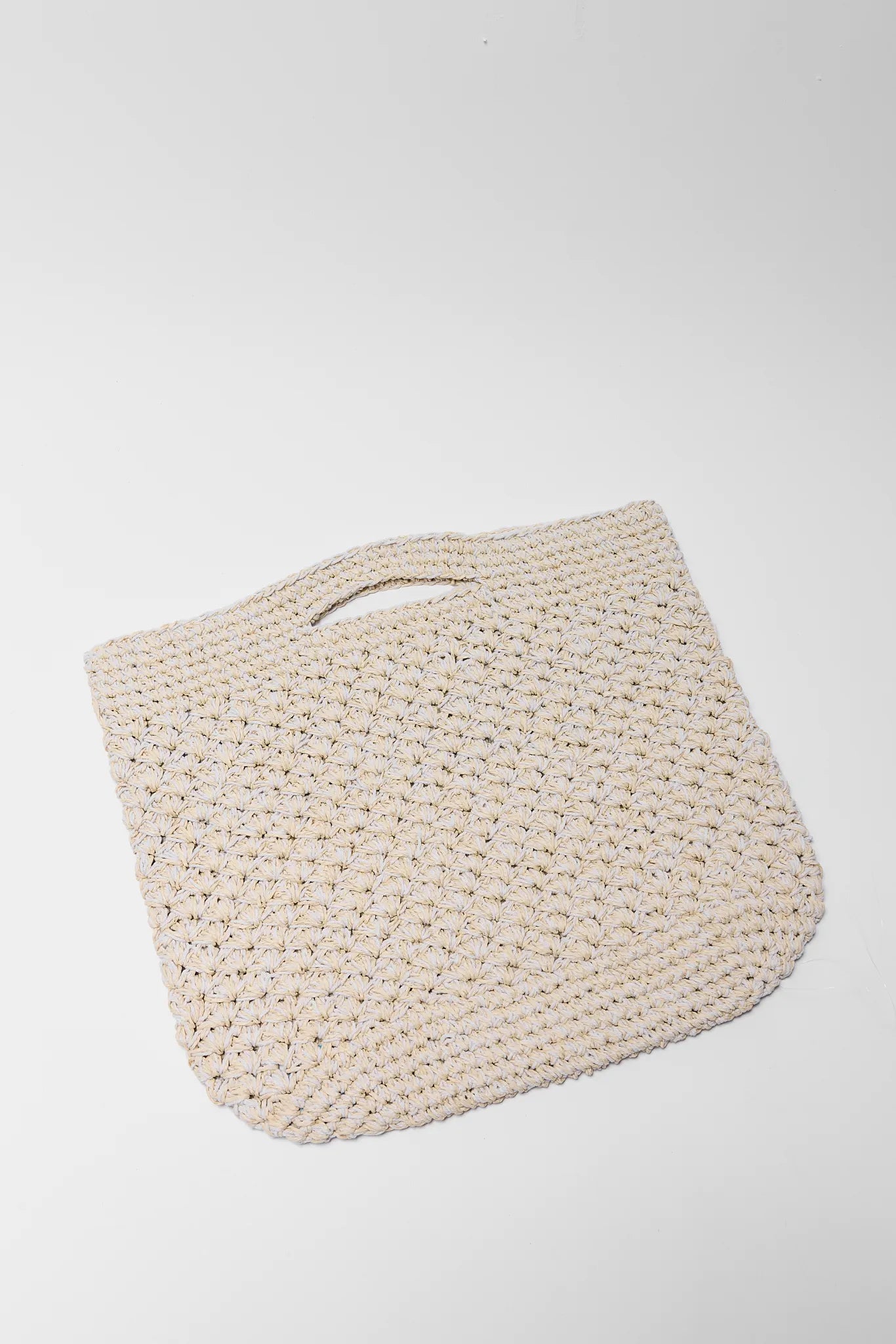 Beige woven handbag on a white background