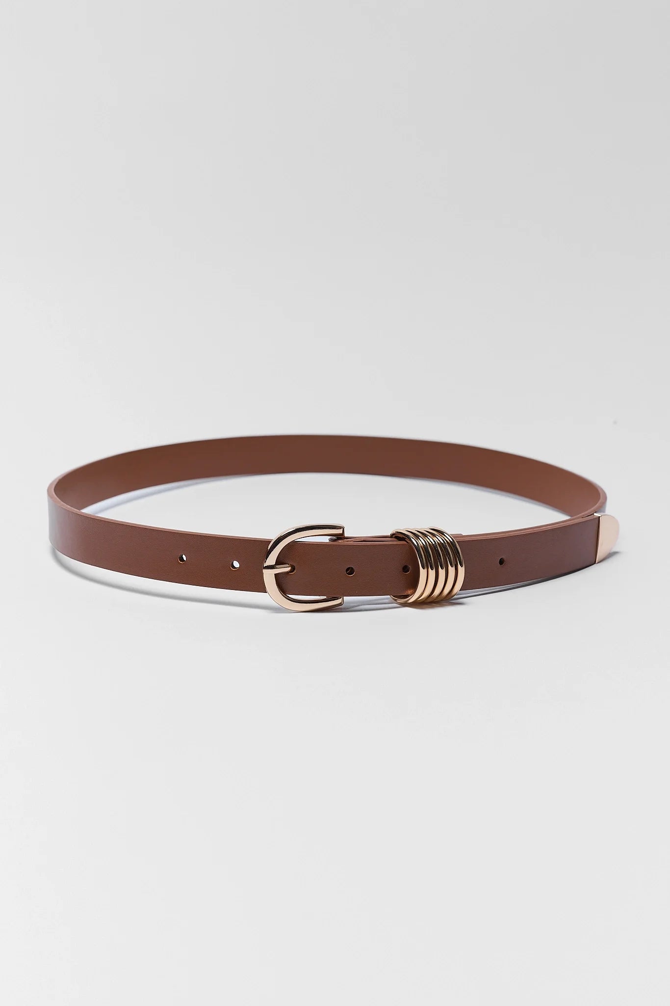 A brown leather belt with a gold-tone buckle and a decorative multi-ring clasp, displayed on a light gray background.