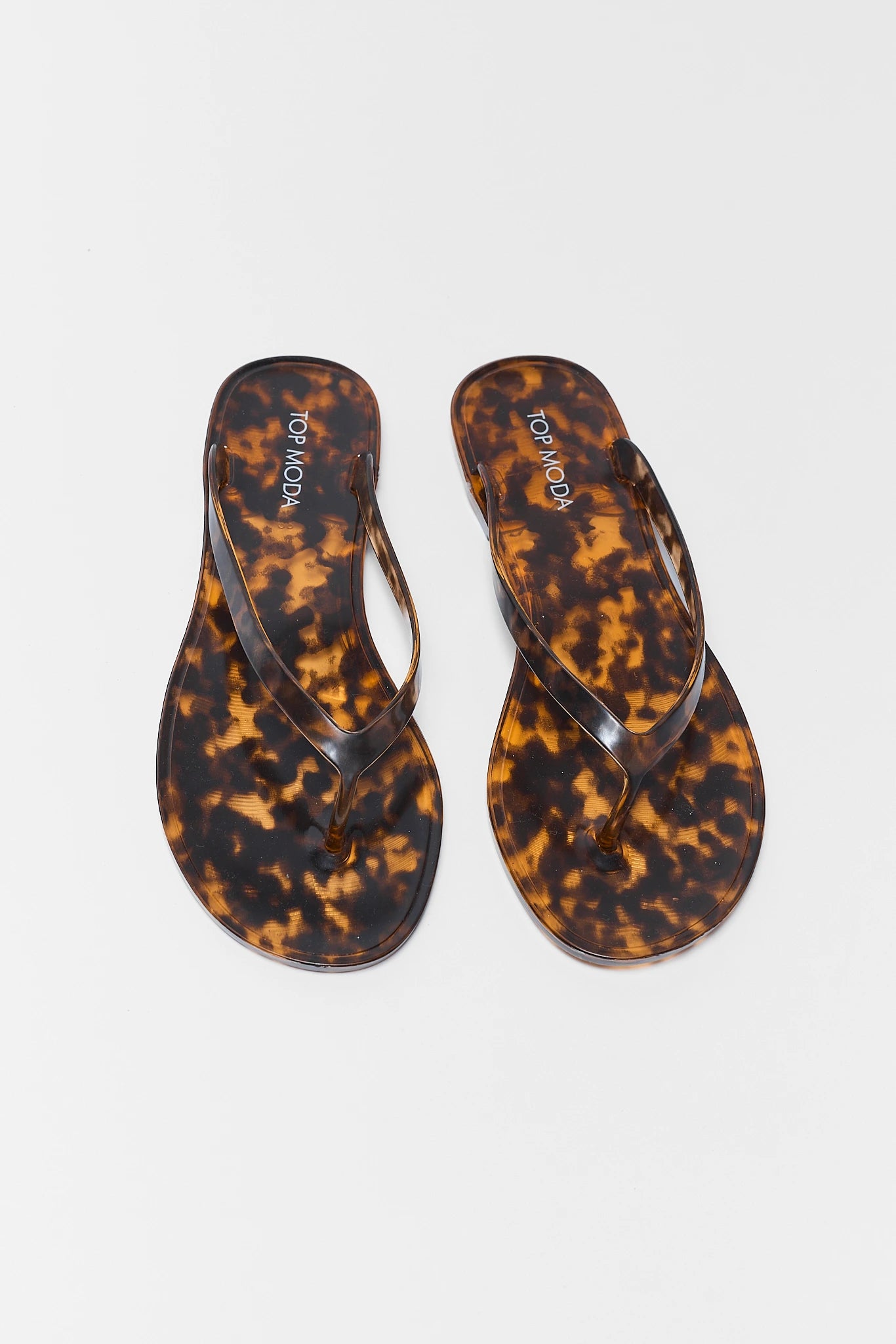 Tortoiseshell flip-flops on a white background two