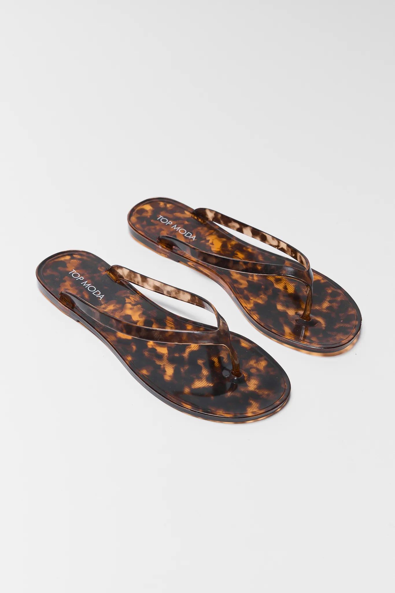 pair of Tortoiseshell flip-flops on a white background